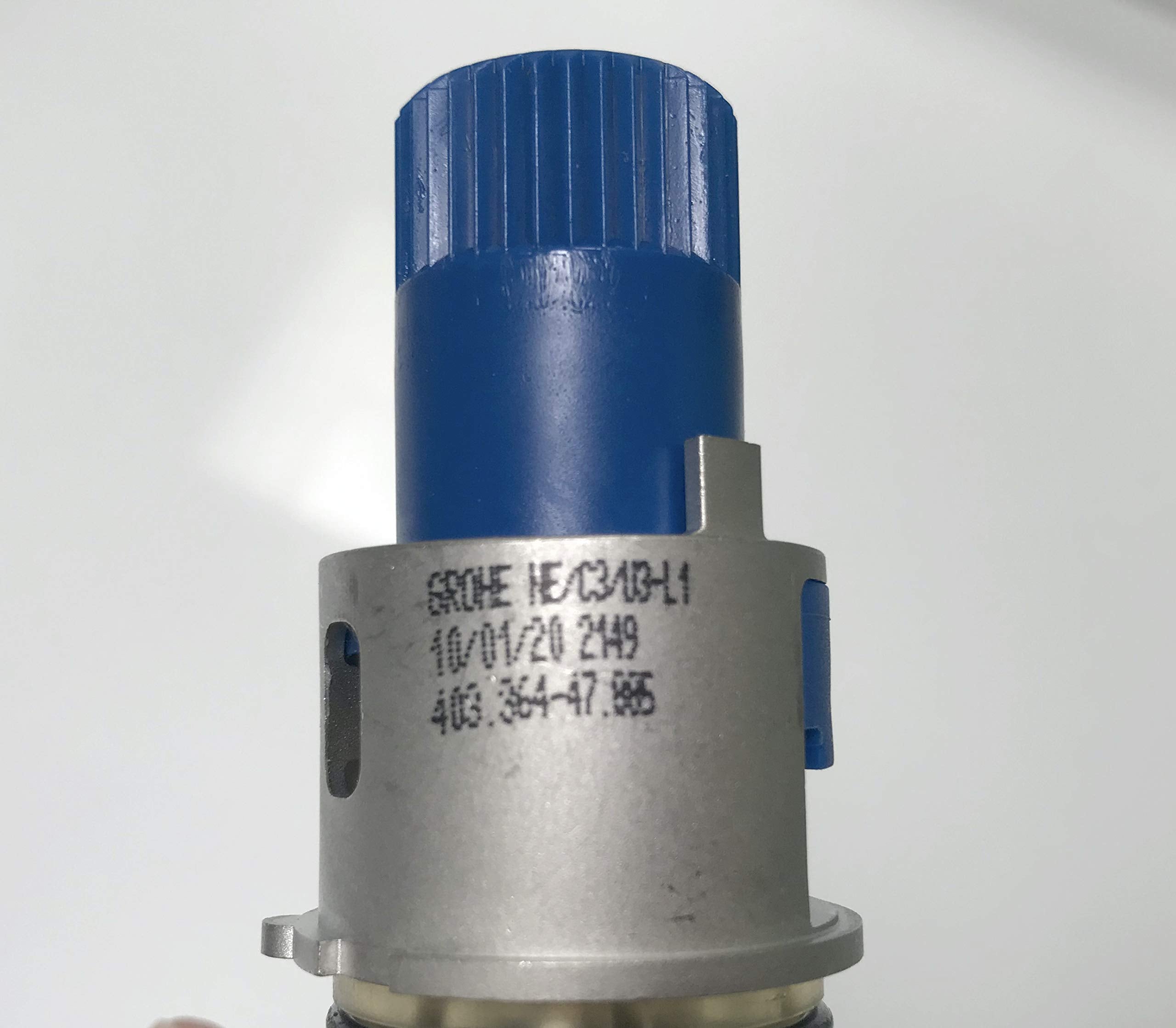 Grohe thermostatic cartridge with blue cap and chrome metal body showing part numbers and specifications.