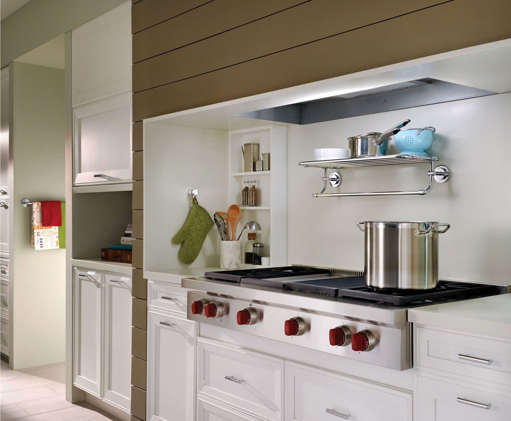Chrome single robe hook mounted on white kitchen wall above stovetop area.