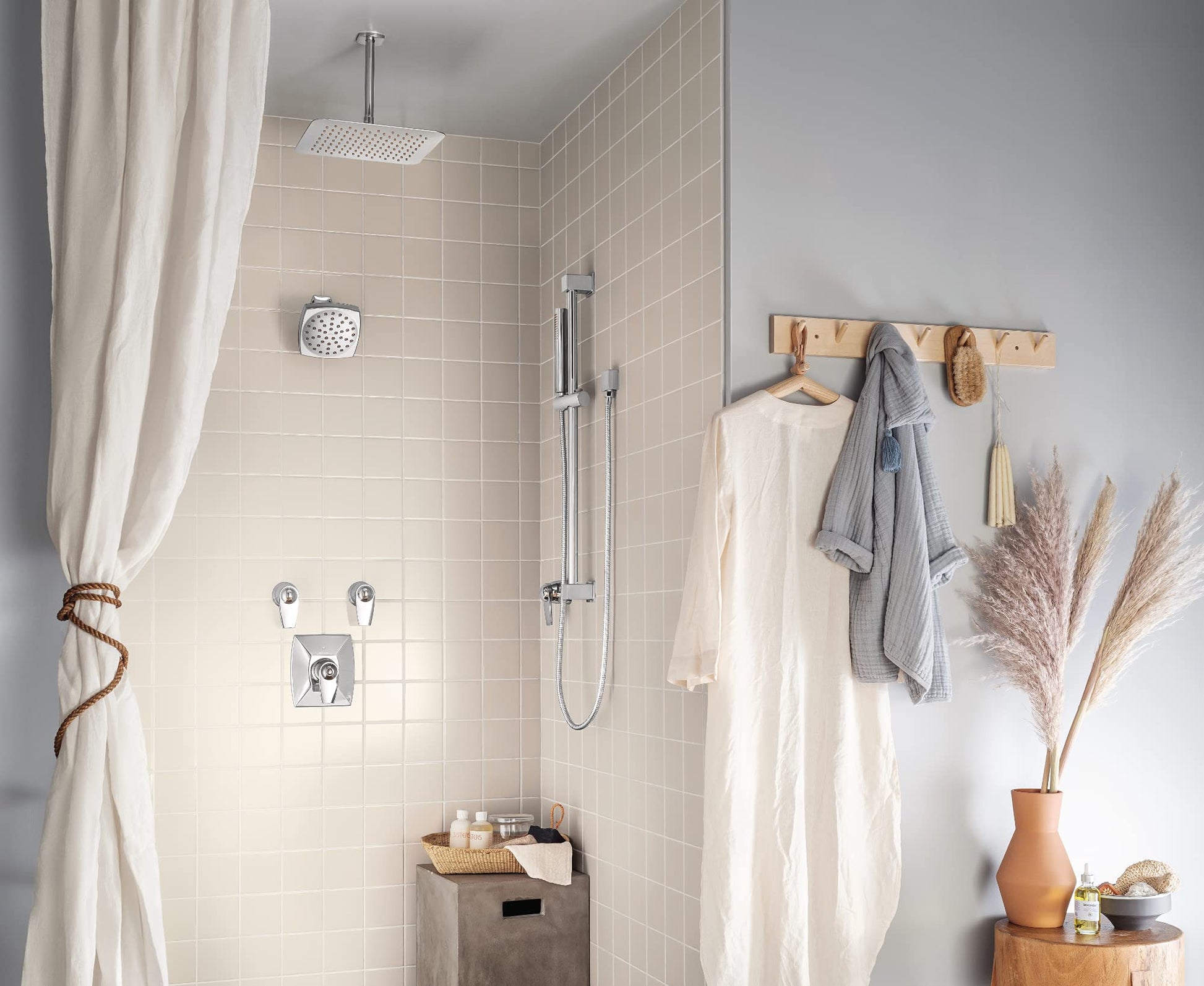 Chrome 12-inch square rainshower head mounted on ceiling with thin profile design in bathroom shower.