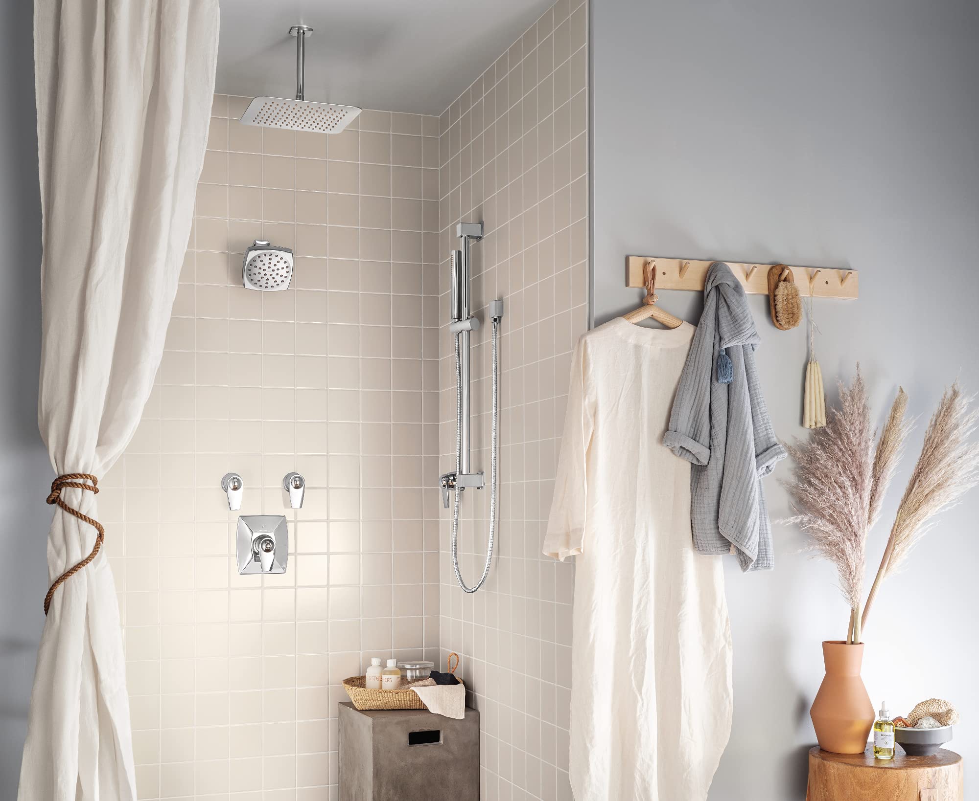 Chrome 12-inch square rainshower head mounted on ceiling with thin profile design in bathroom shower.