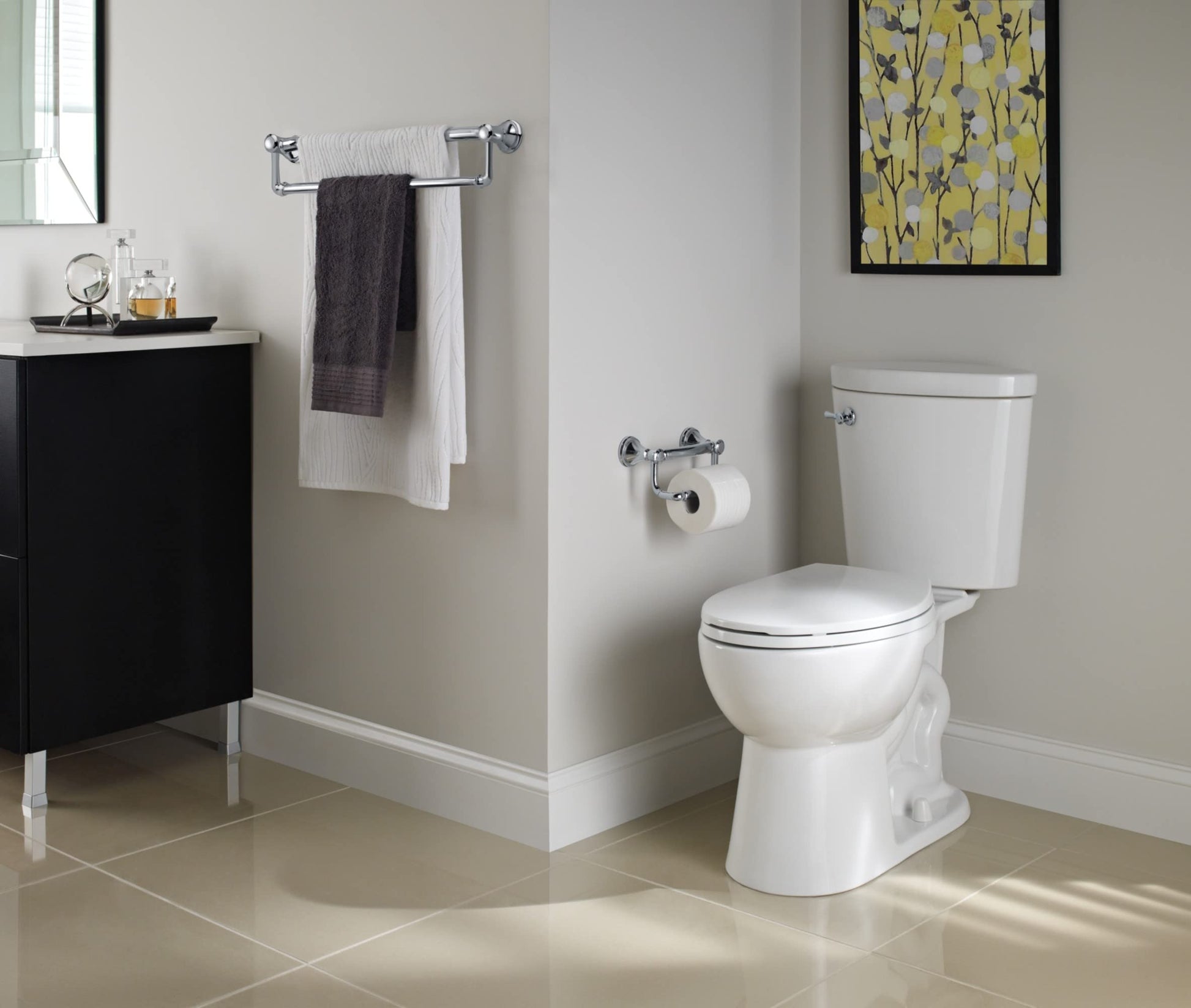 Stainless steel towel bar with assist handles mounted on bathroom wall, holding two folded towels.
