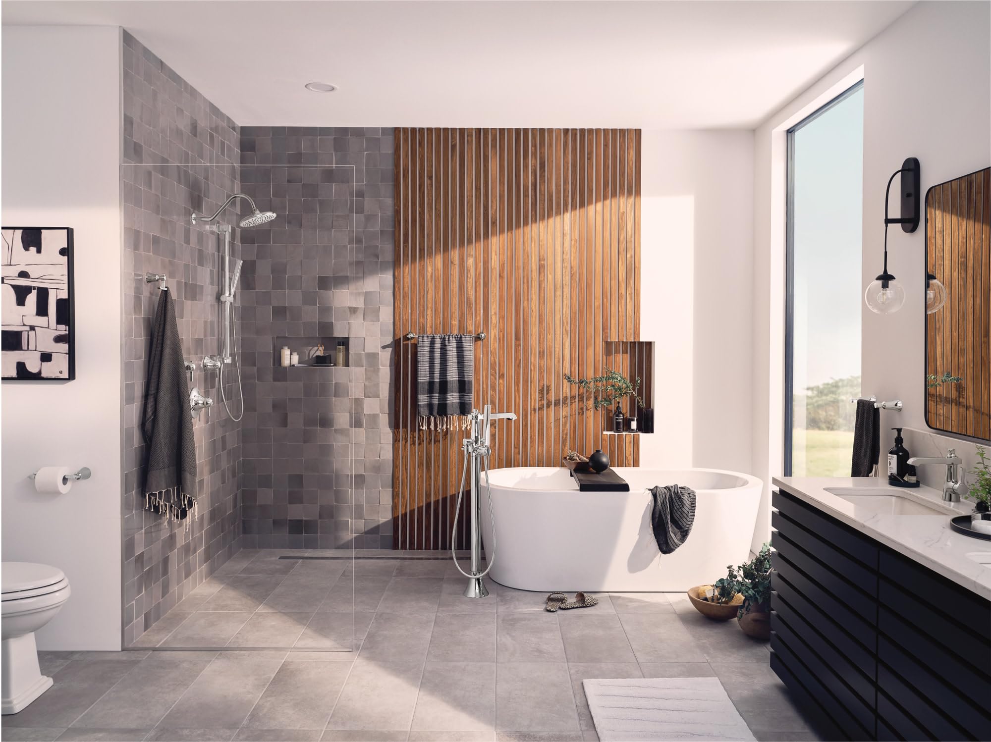 Polished nickel freestanding floor-mounted tub filler with single handle and attached handshower shown in modern bathroom nex