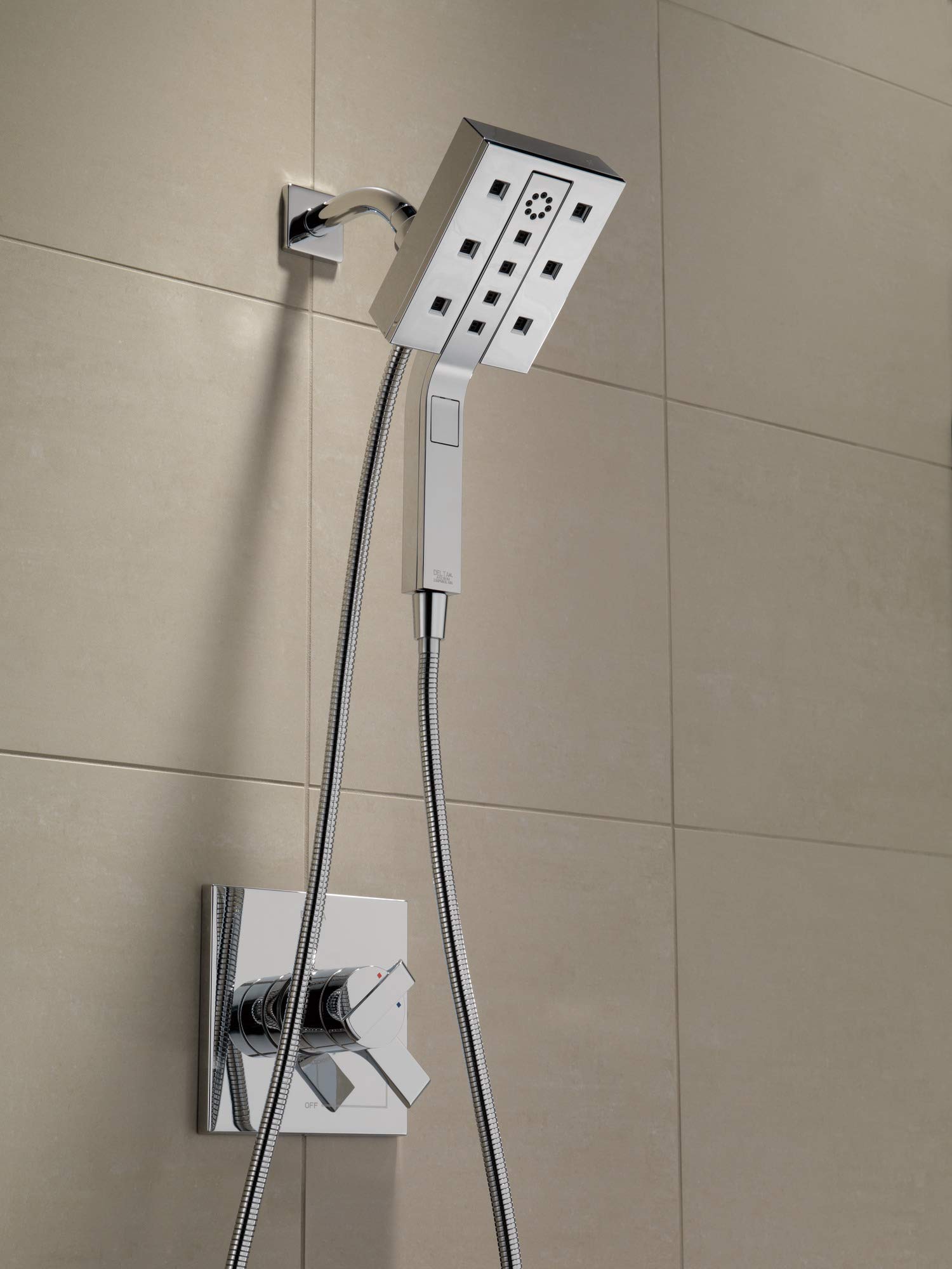 Black stainless steel shower arm with rectangular mounting bracket installed on tiled wall.