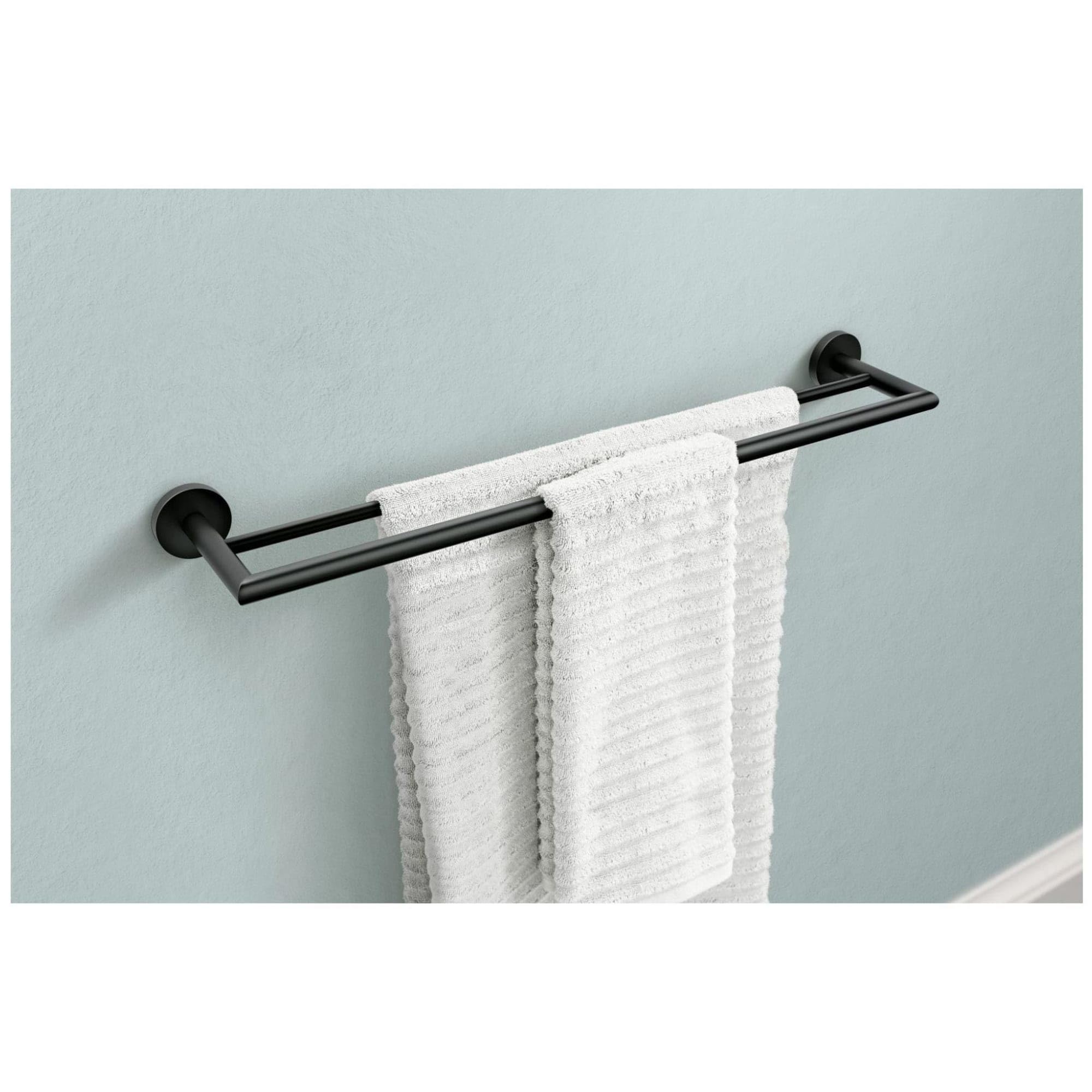 Chrome double towel bar mounted on wall with two white towels draped across parallel bars.