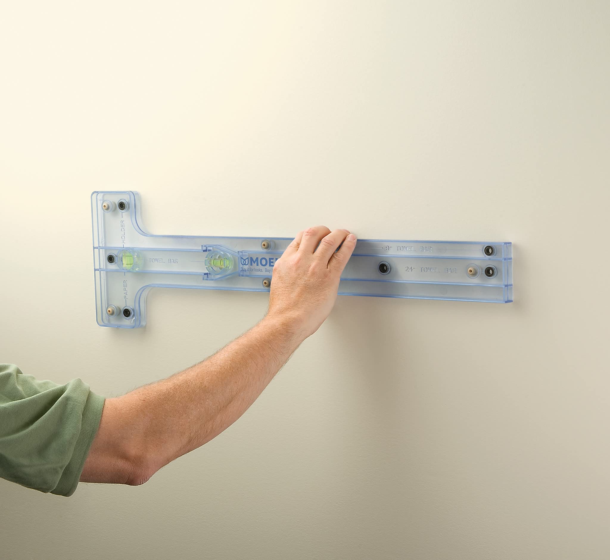 Chrome wall-mounted towel ring with rounded rectangular design and mounting bracket hardware.