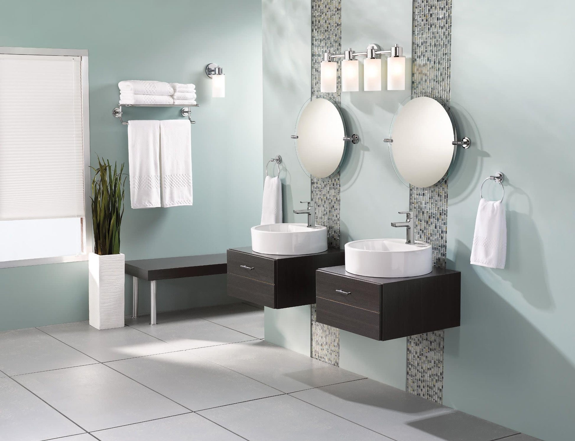 Chrome single-handle bathroom faucet mounted above white round sink on dark wood vanity.