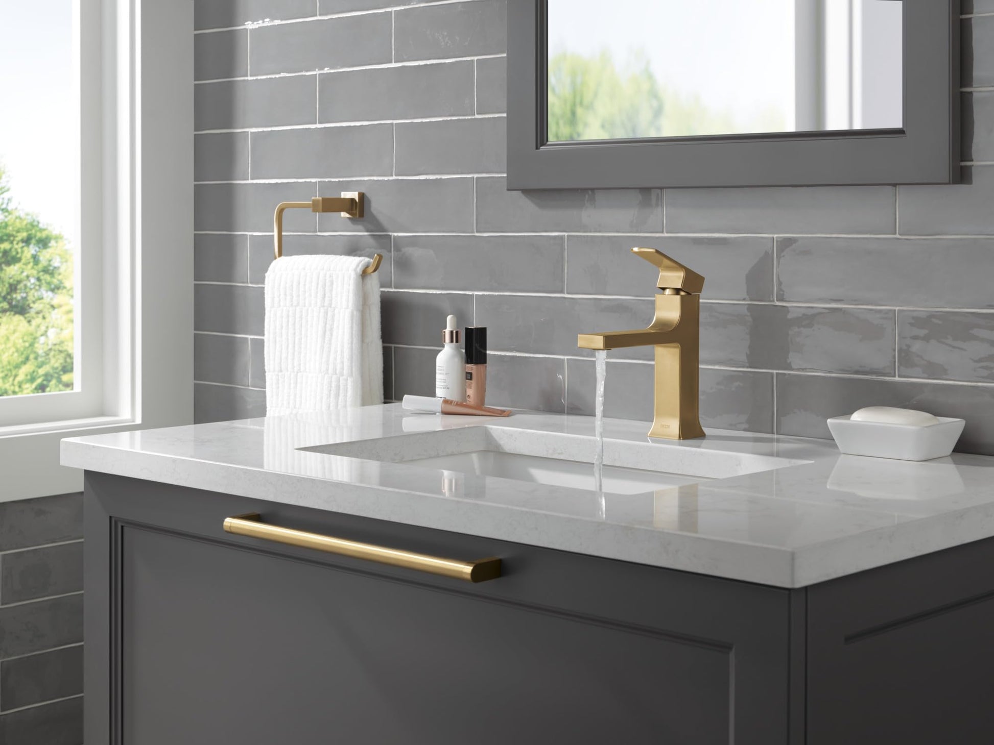 Champagne bronze single-handle bathroom faucet with tall spout mounted on white countertop sink.