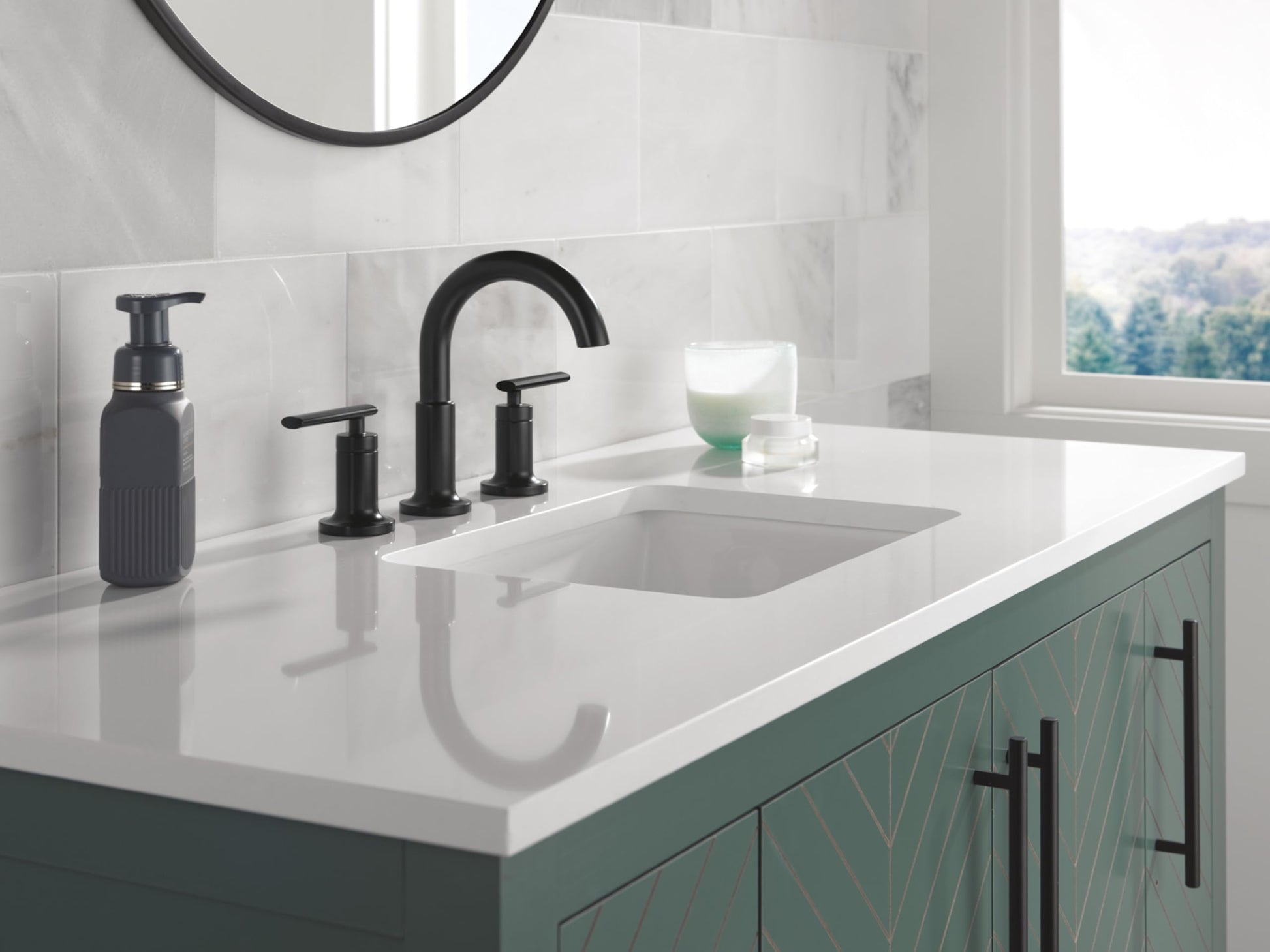 Champagne bronze two-handle widespread bathroom faucet with curved spout installed on white countertop.