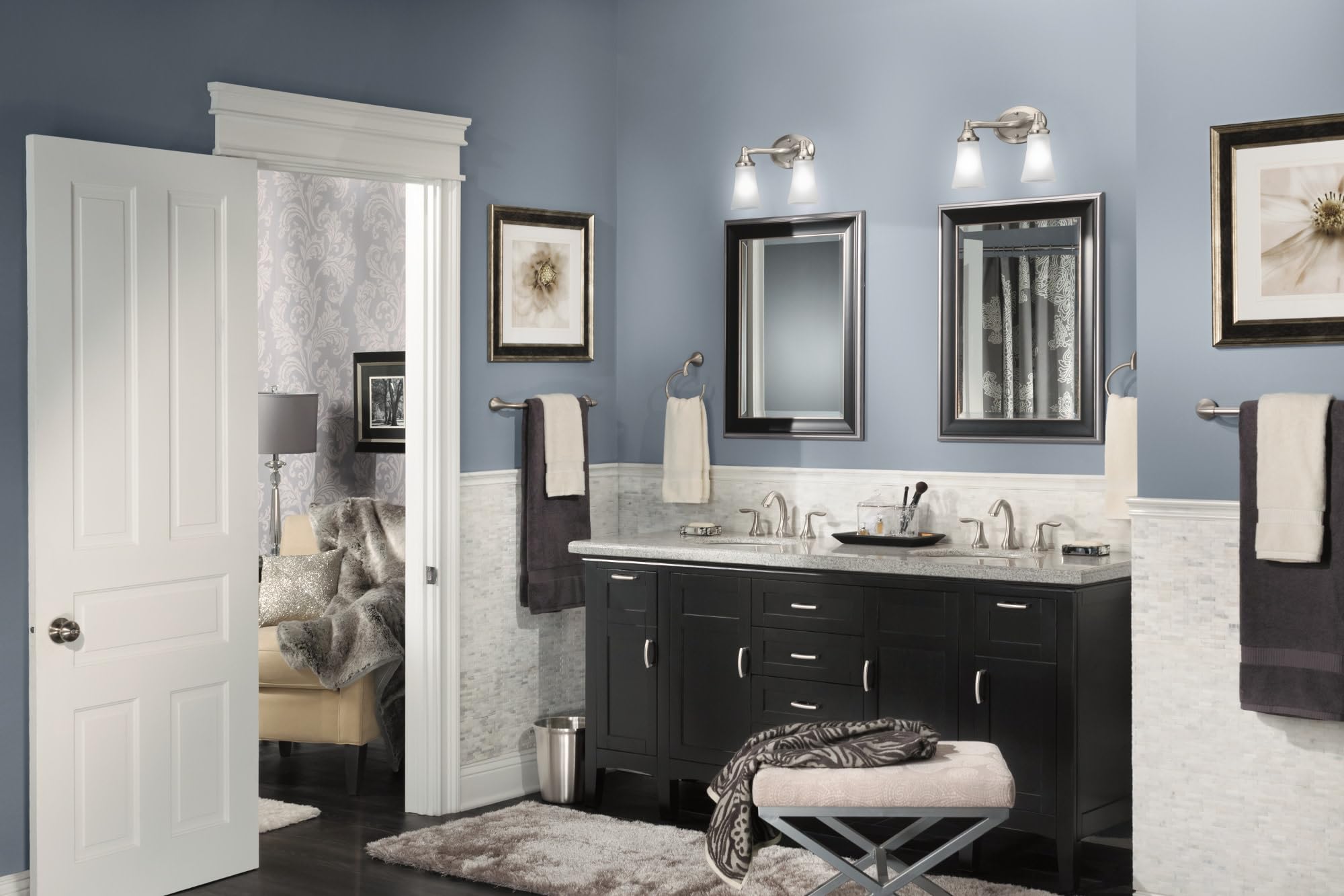 Brushed nickel two-handle widespread bathroom sink faucet valve trim with curved spout and lever handles installed on double 