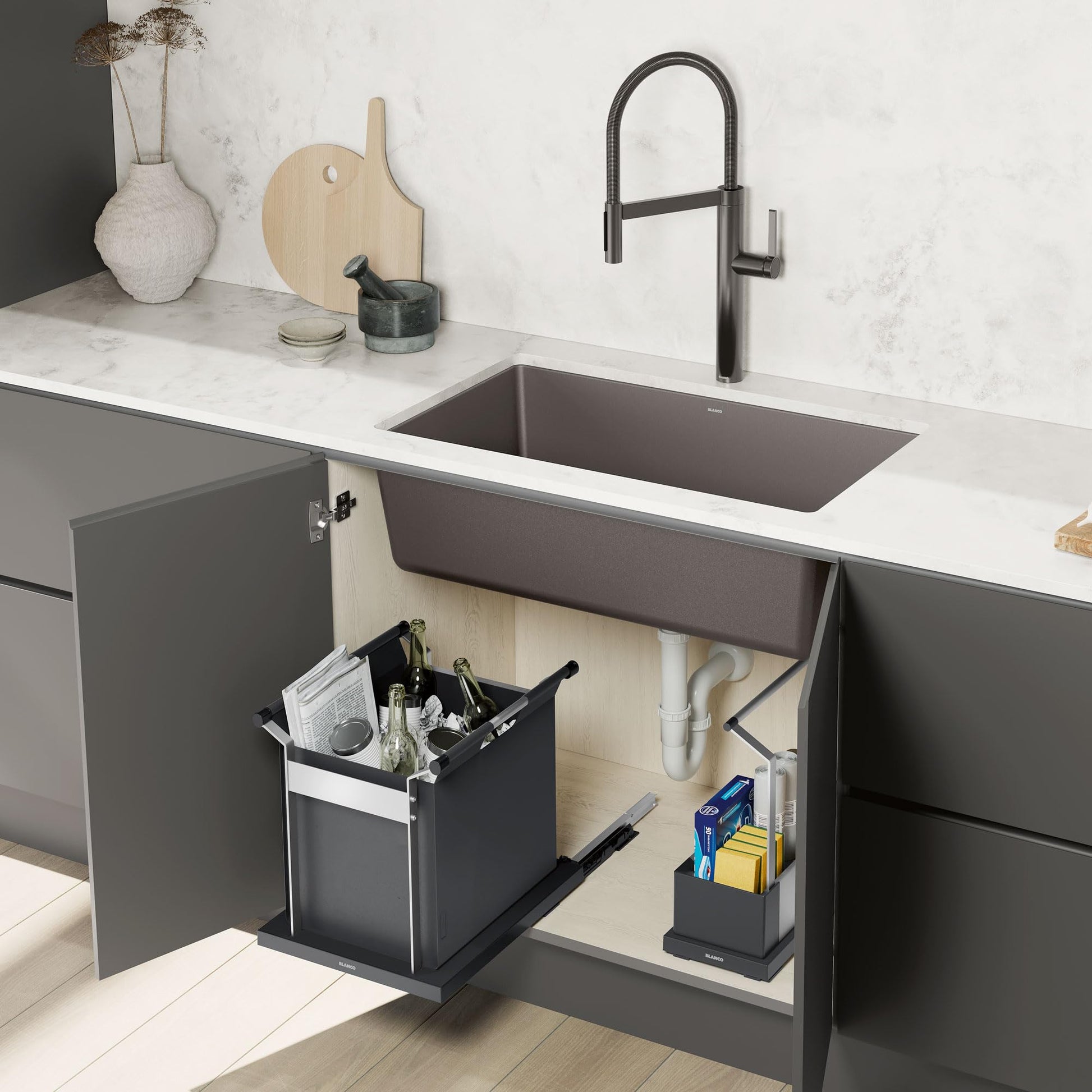 Black rectangular storage container with handles installed under kitchen sink cabinet.