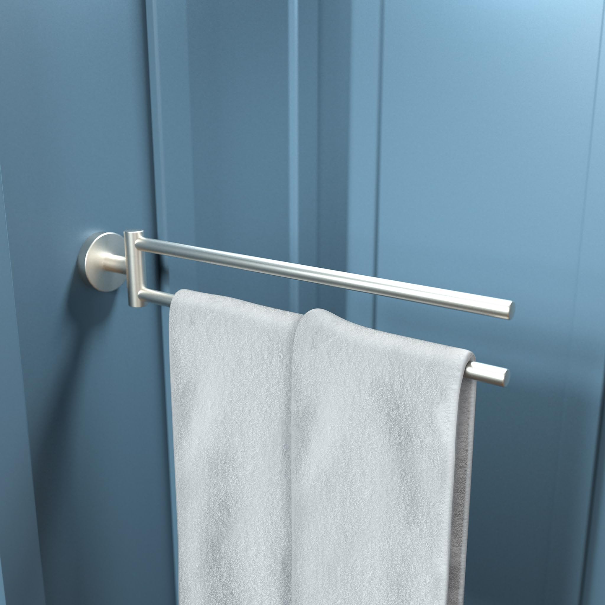Brushed nickel dual towel bar mounted on blue wall with white towels draped over both horizontal bars.