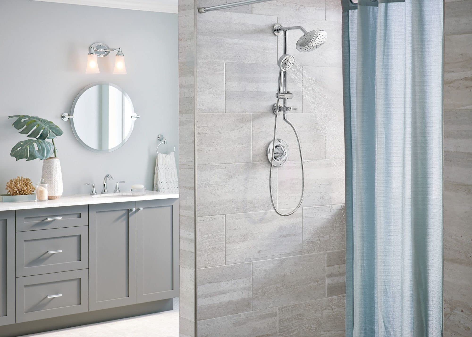 Chrome circular towel ring mounted on white bathroom wall next to vanity.
