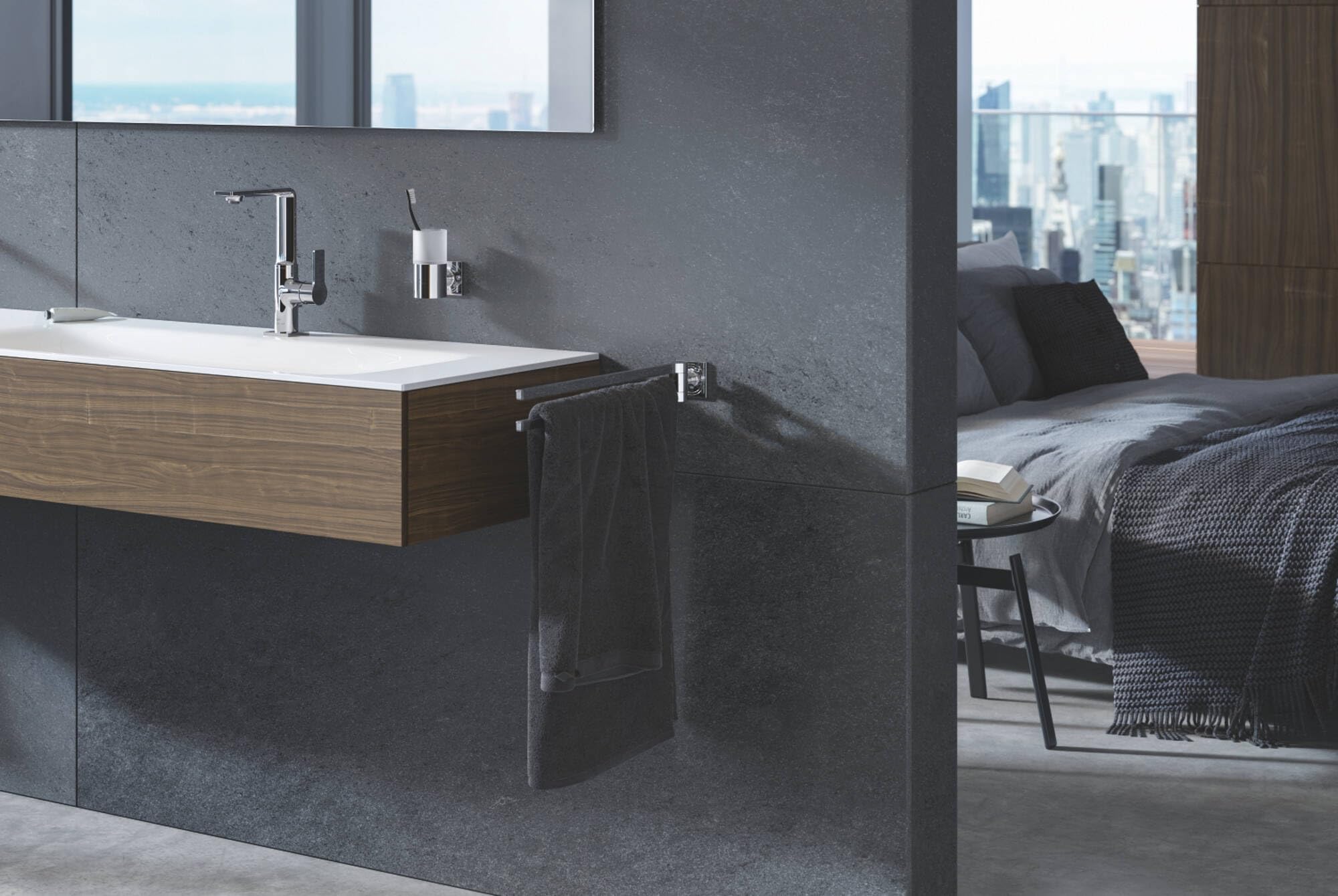 Chrome soap dispenser mounted on gray bathroom wall next to sink with wooden vanity.