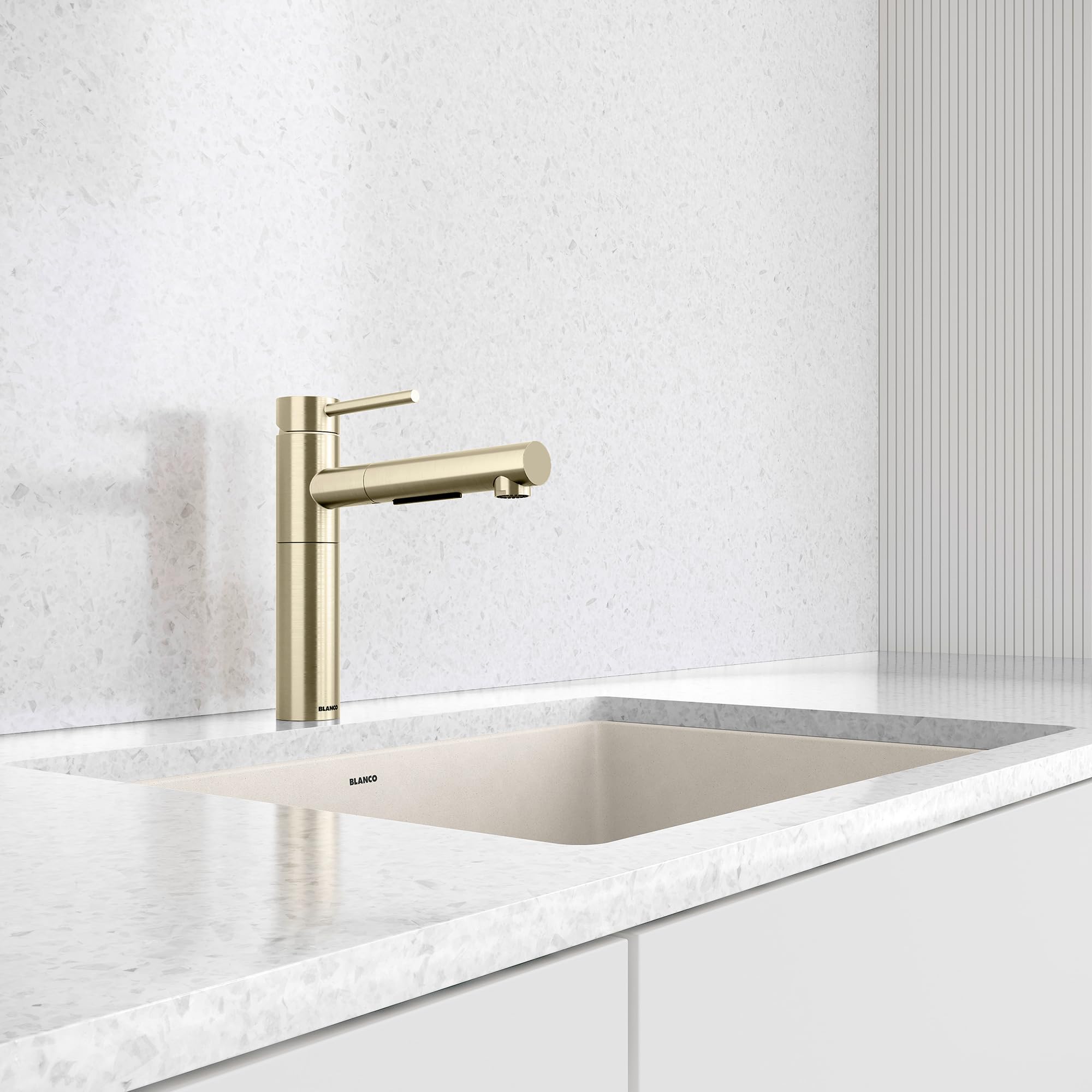 Satin gold pull-out kitchen faucet with single lever handle mounted above a white undermount sink.