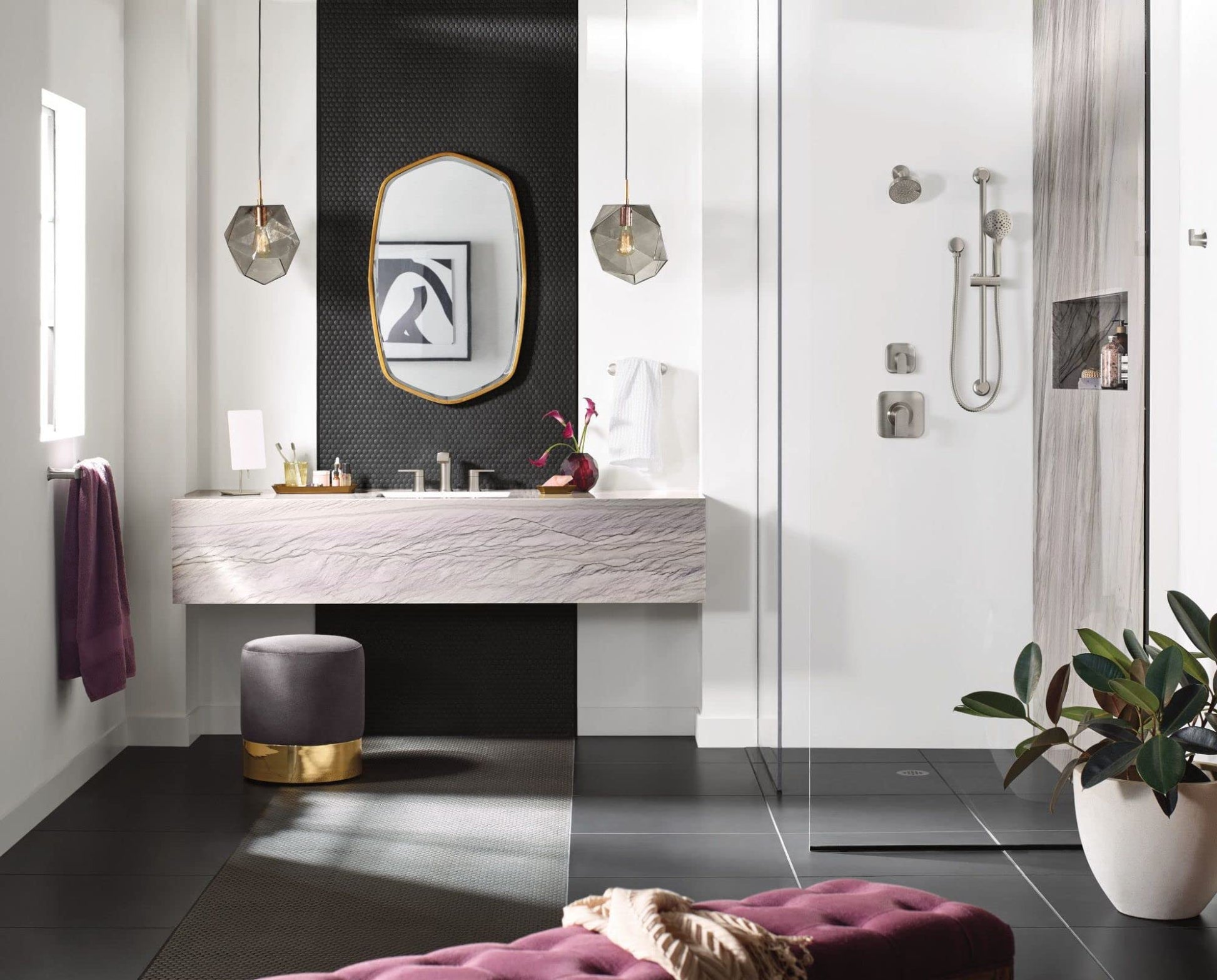 Brushed nickel single-handle shower trim kit with cylindrical handle mounted on tiled bathroom wall above shower enclosure.