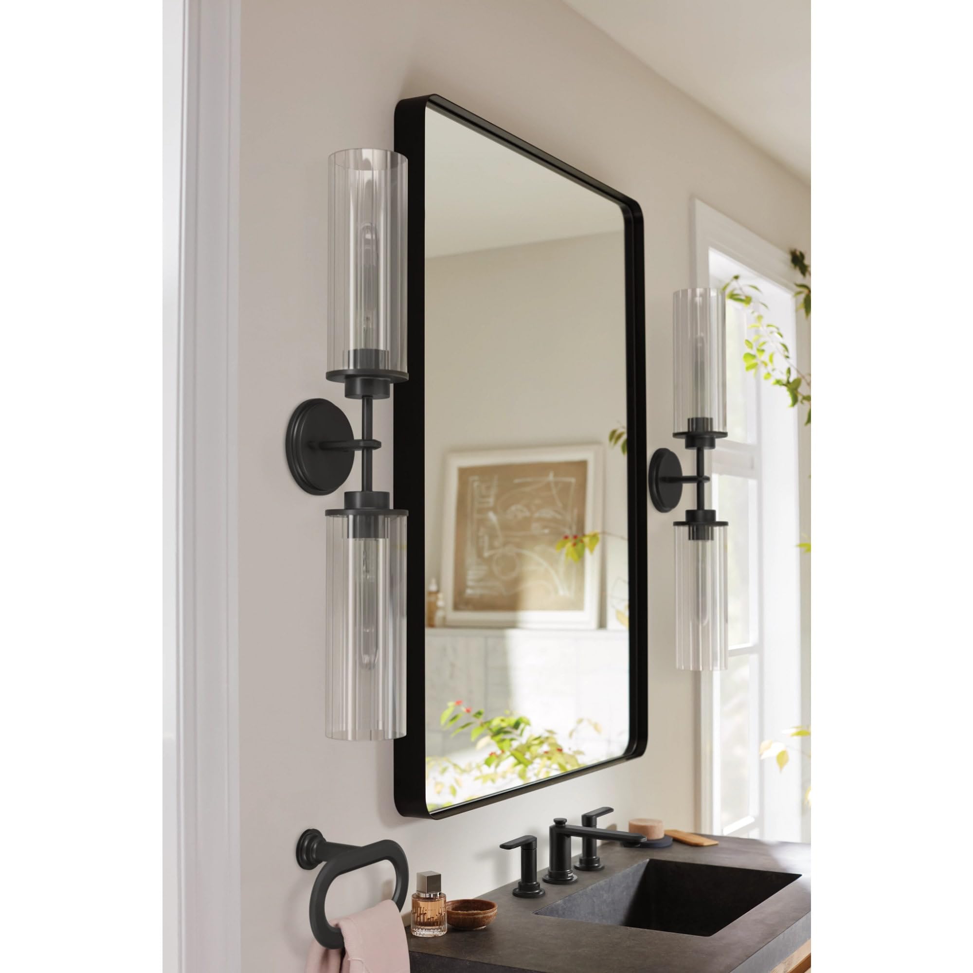 Brushed nickel two-handle widespread bathroom sink faucet with curved spout and lever handles.