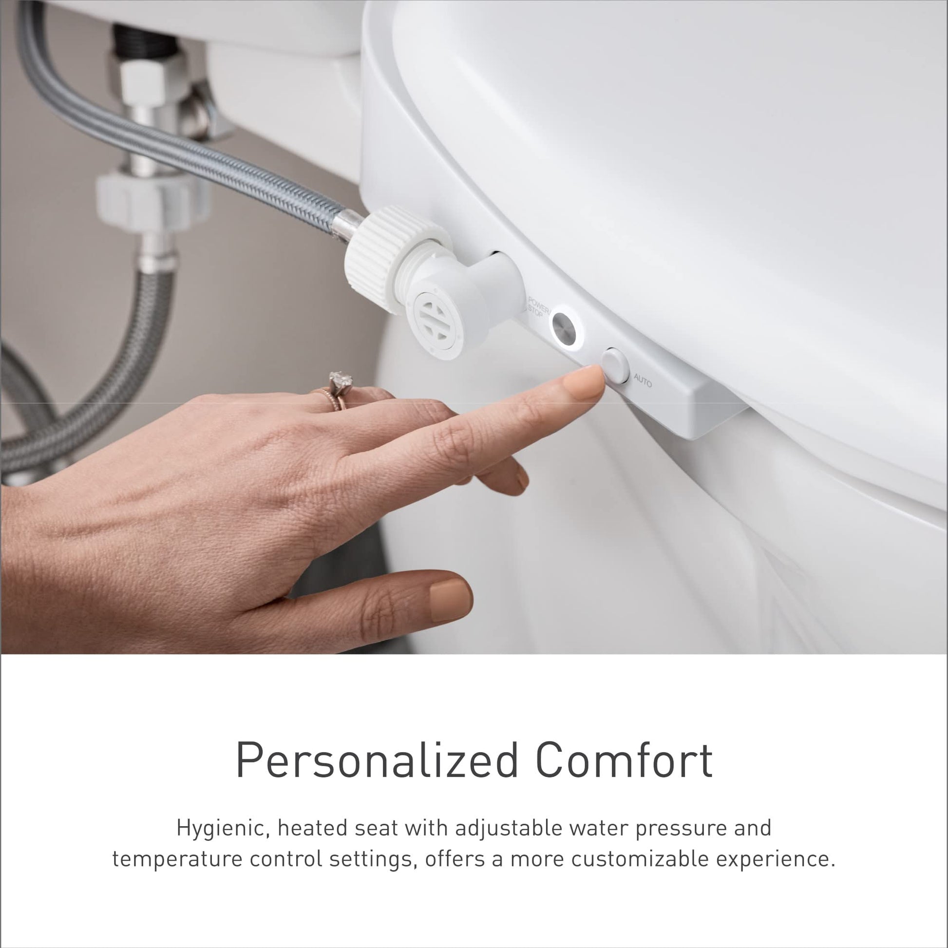 White electronic bidet toilet seat with control panel and water supply hose connected to plumbing.