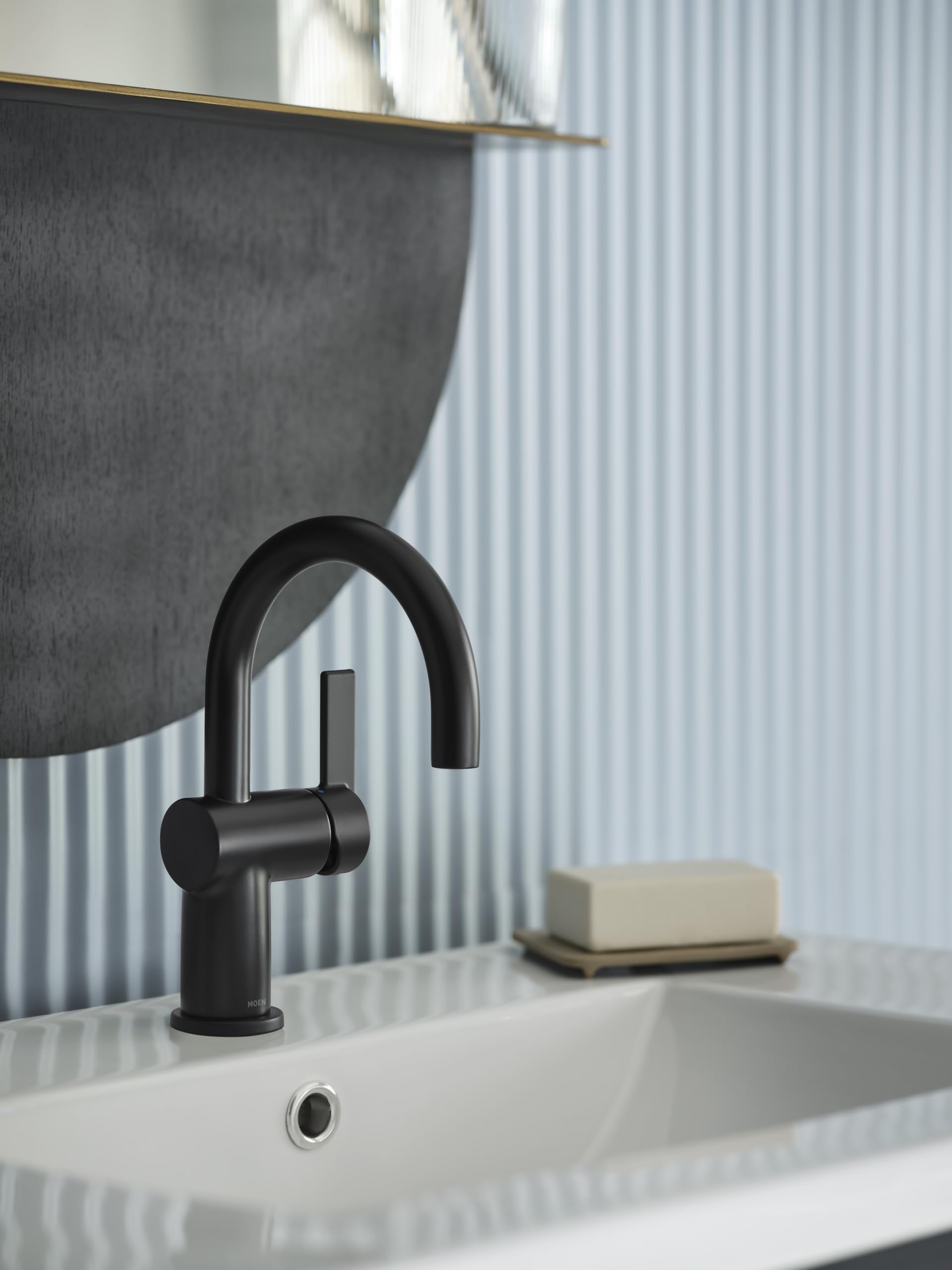 Matte black single-handle bathroom faucet with curved spout mounted above white vessel sink.