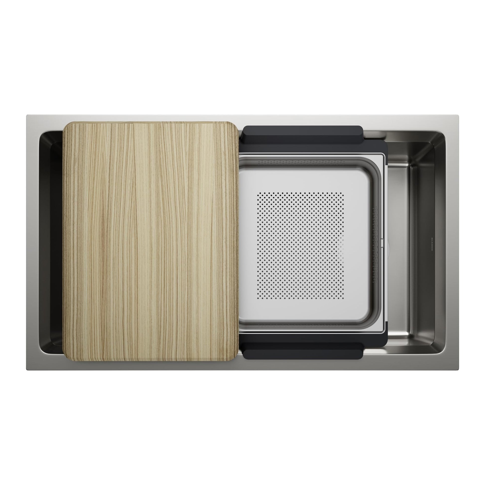 Stainless steel kitchen sink with wooden cutting board, white colander insert, and black accessories, viewed from above.