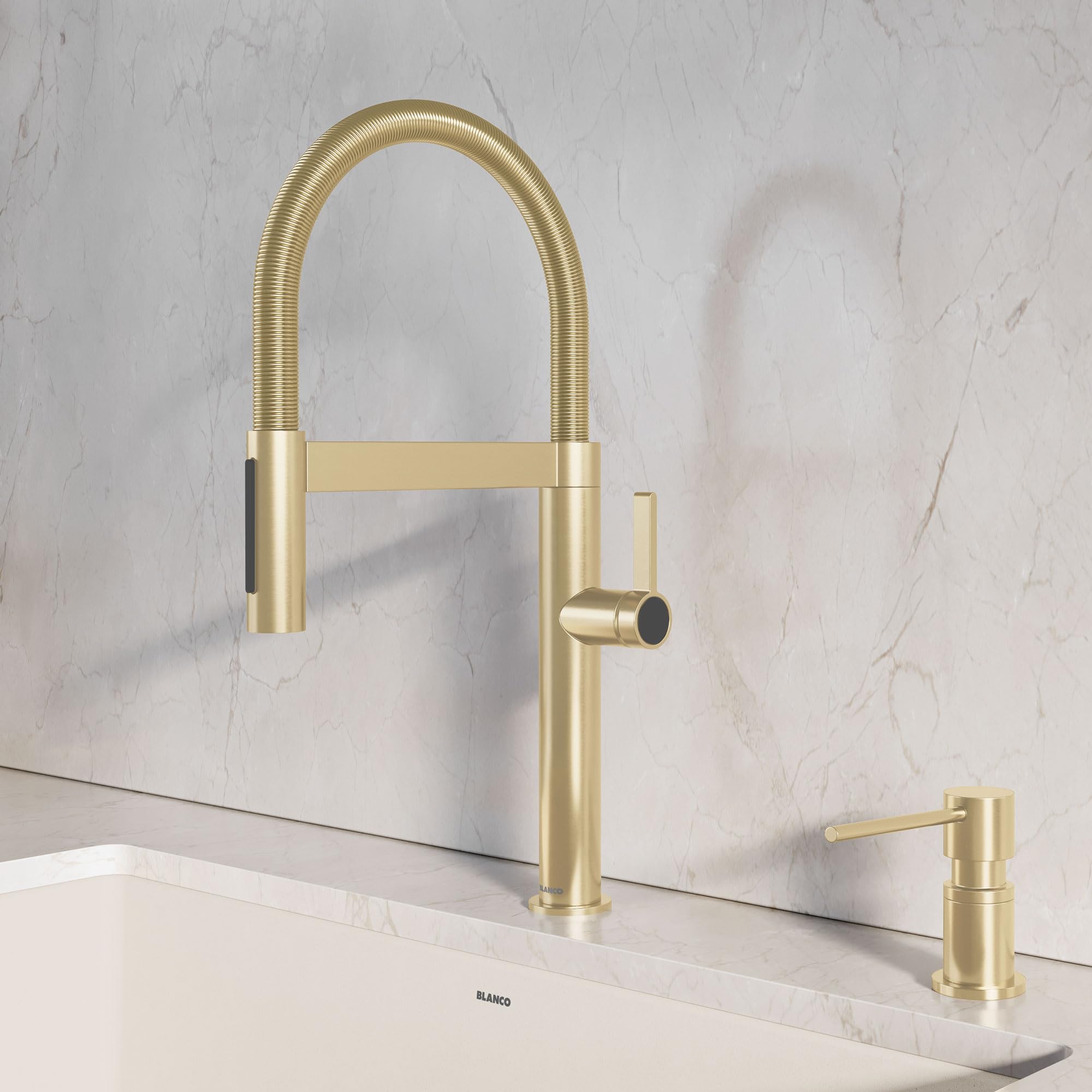 Satin gold mini faucet with curved spout and matching soap dispenser on marble countertop.