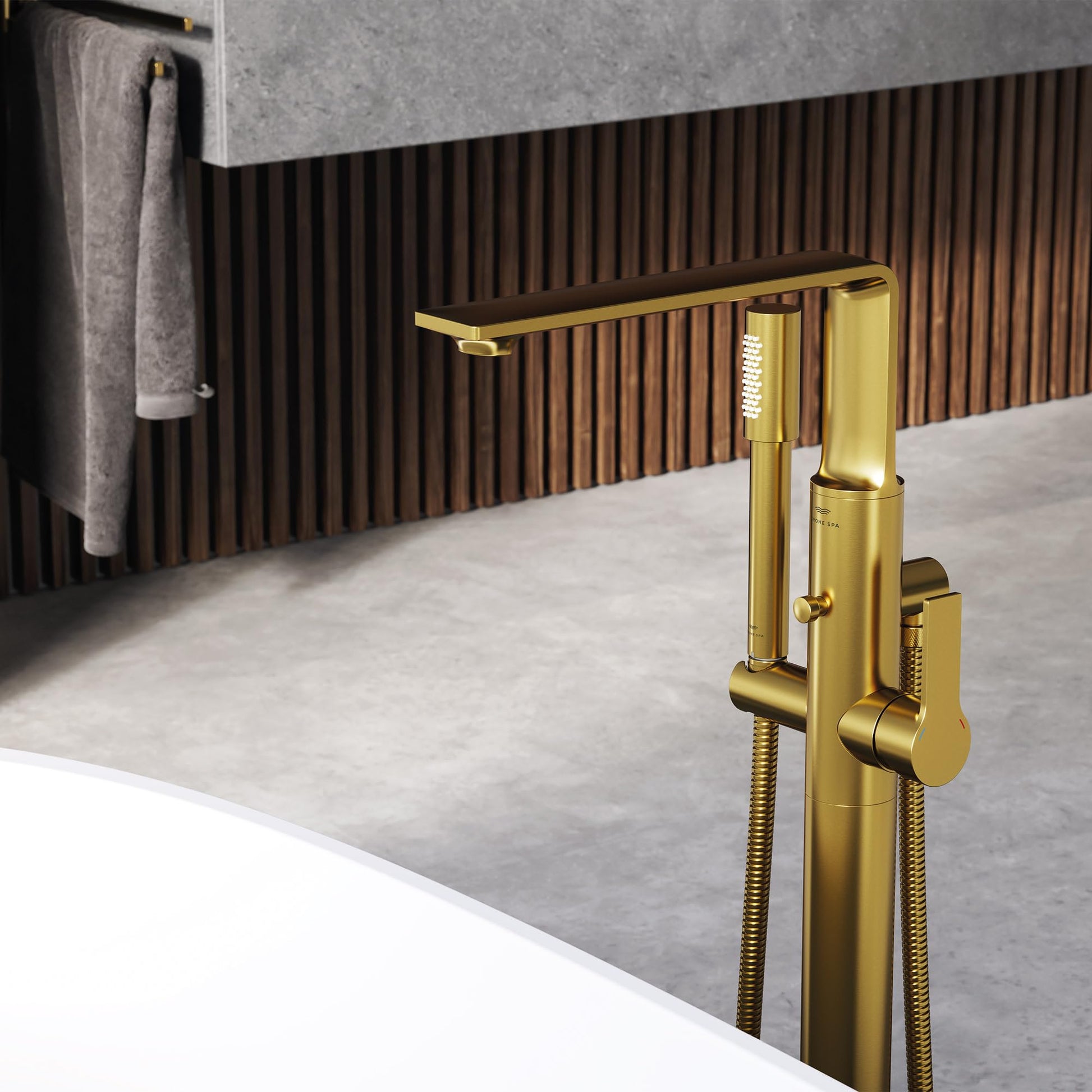 Gold single-handle freestanding tub faucet with attached hand shower and flexible hose.