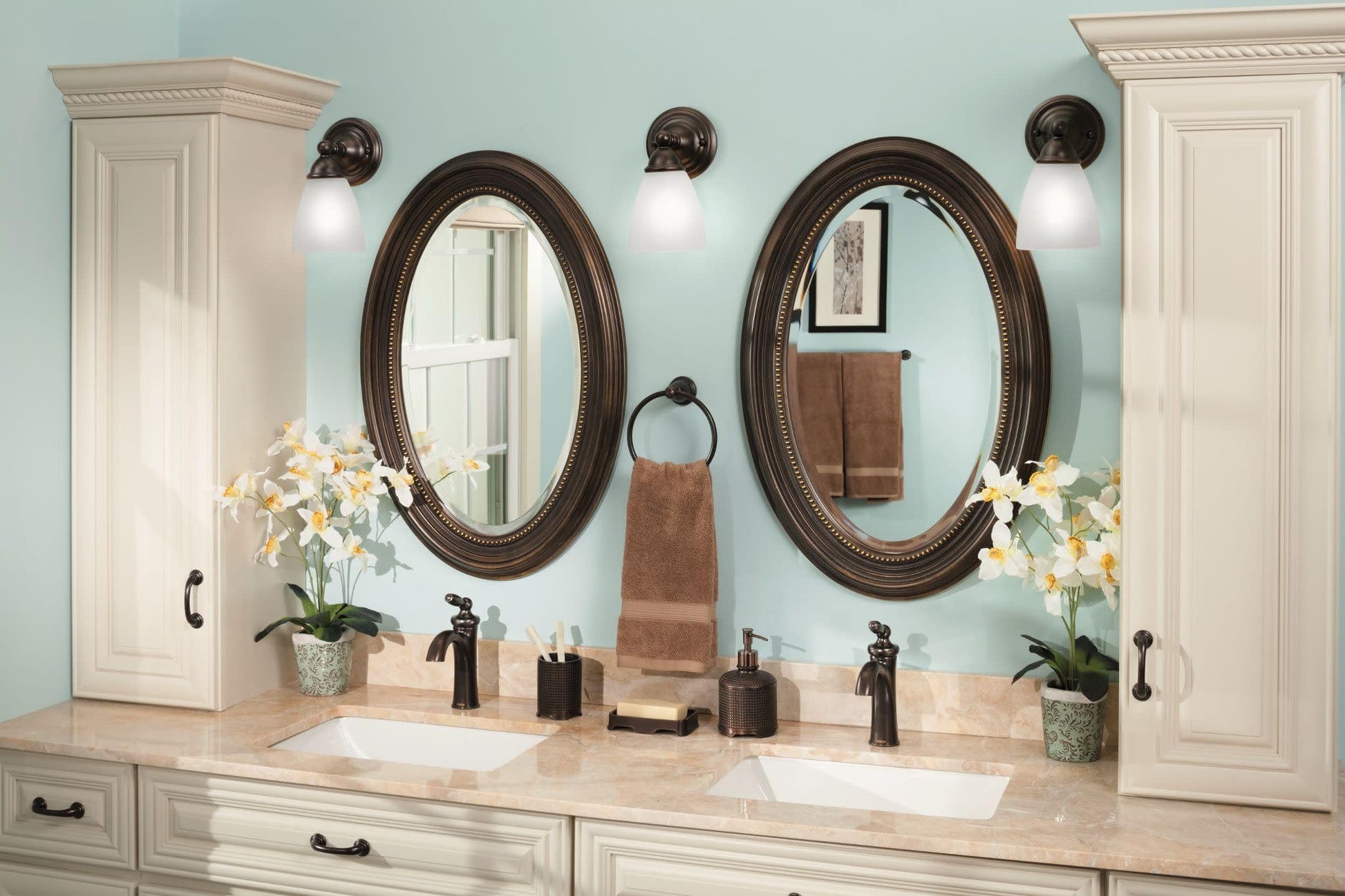 Oil-rubbed bronze single-handle low-arc faucet with curved spout on bathroom vanity counter.