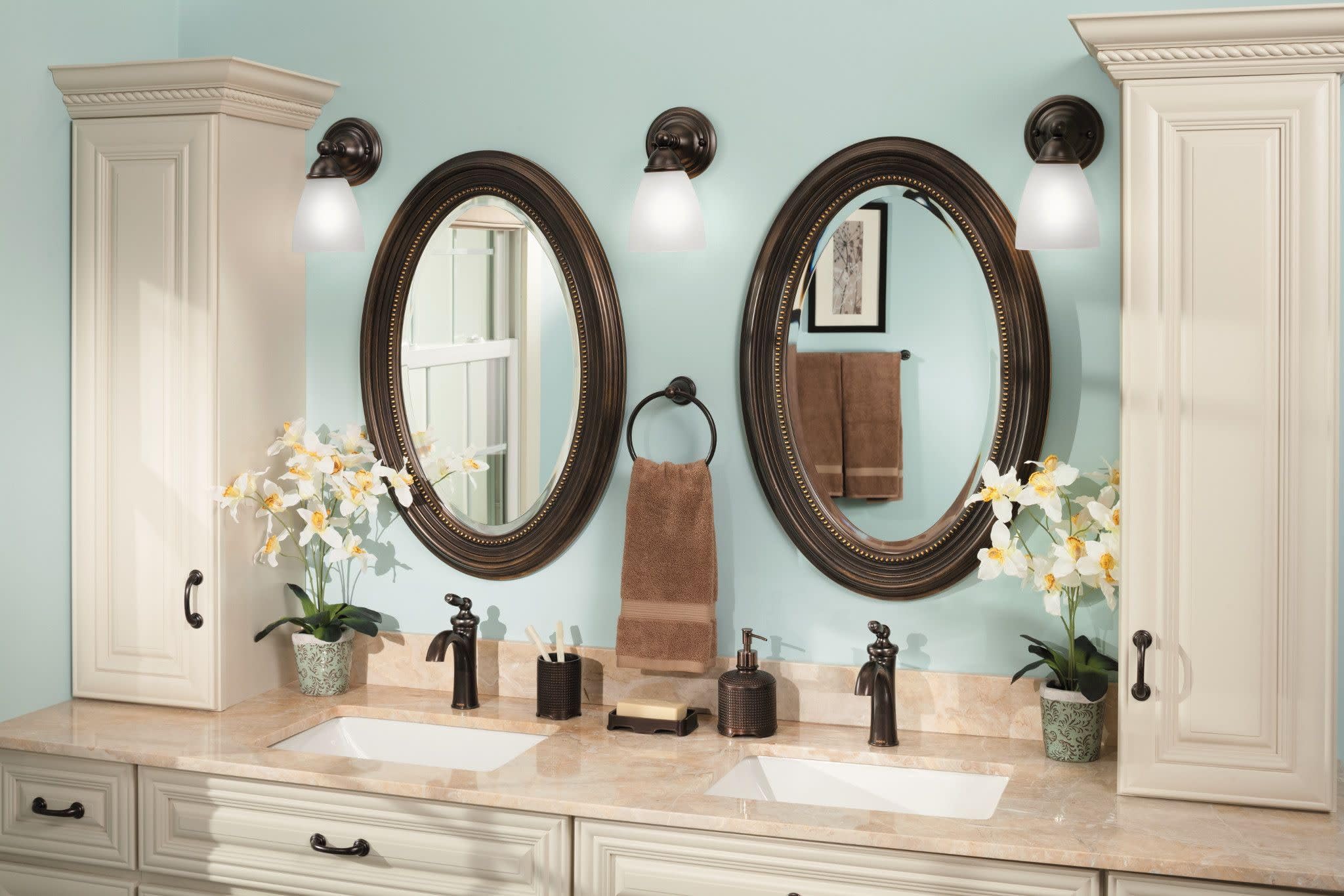 Oil-rubbed bronze single-handle low-arc faucet with curved spout on bathroom vanity counter.