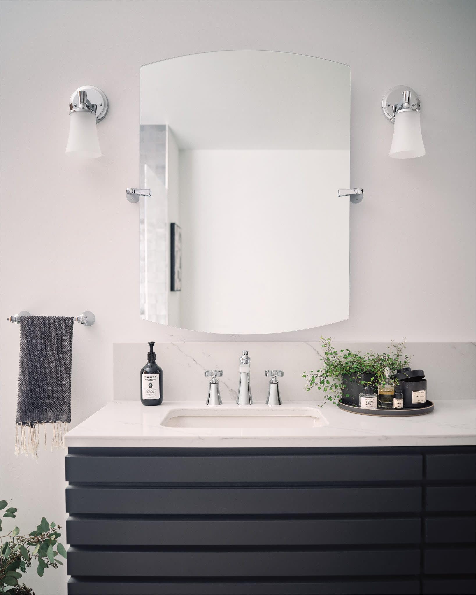 Chrome widespread bathroom faucet with two cross handles and tall spout mounted on white countertop sink.