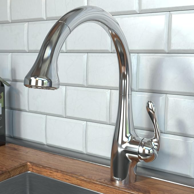 Chrome kitchen faucet with high arc spout and pull-down spray head mounted above sink with white subway tile backsplash.