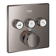 Grohe thermostatic valve trim in dark graphite with three function buttons and central temperature control dial displaying 38