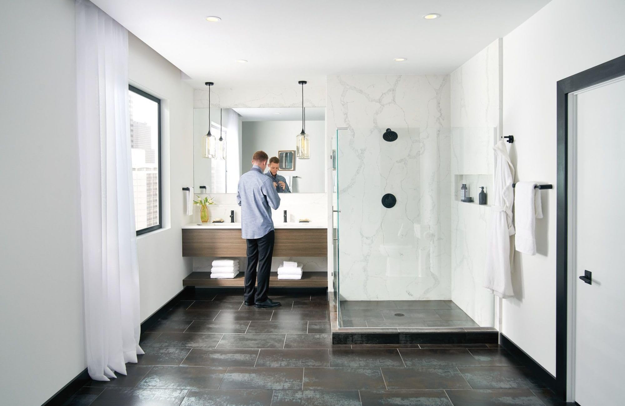 Matte black straight towel bar mounted horizontally on white marble shower wall in modern bathroom.