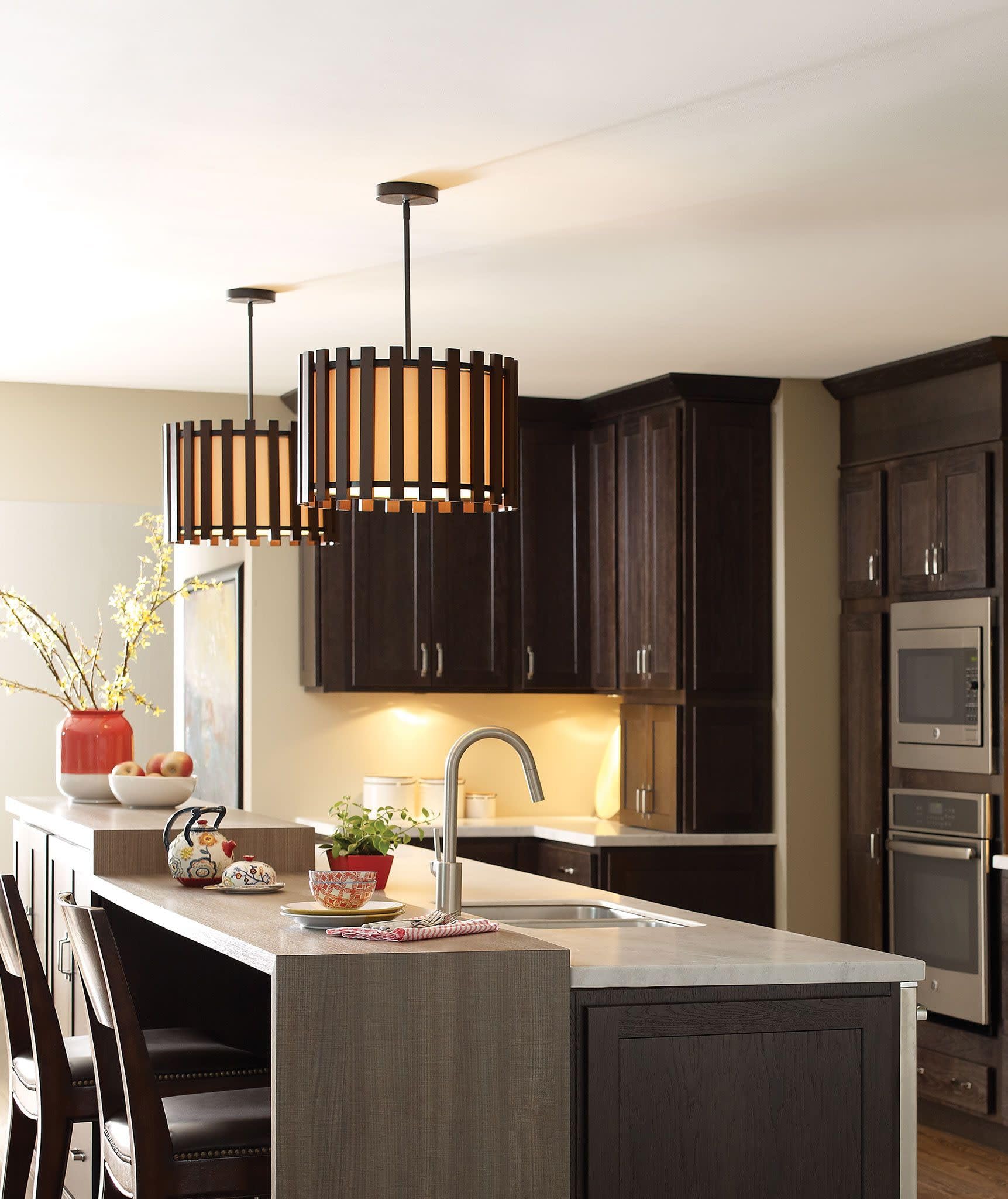 Spot-resistant stainless steel pulldown kitchen faucet with single handle mounted above white countertop sink.
