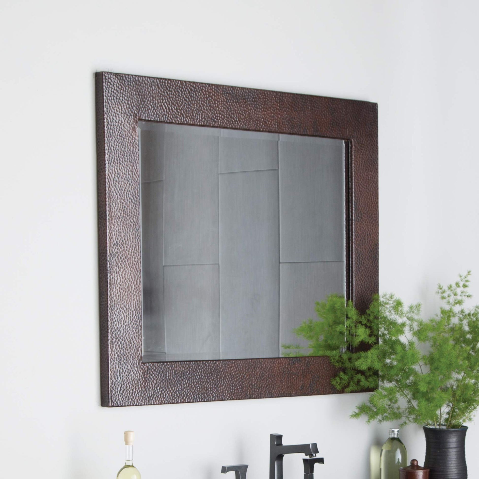 Large rectangular mirror with antique copper hammered metal frame and reflective glass surface.