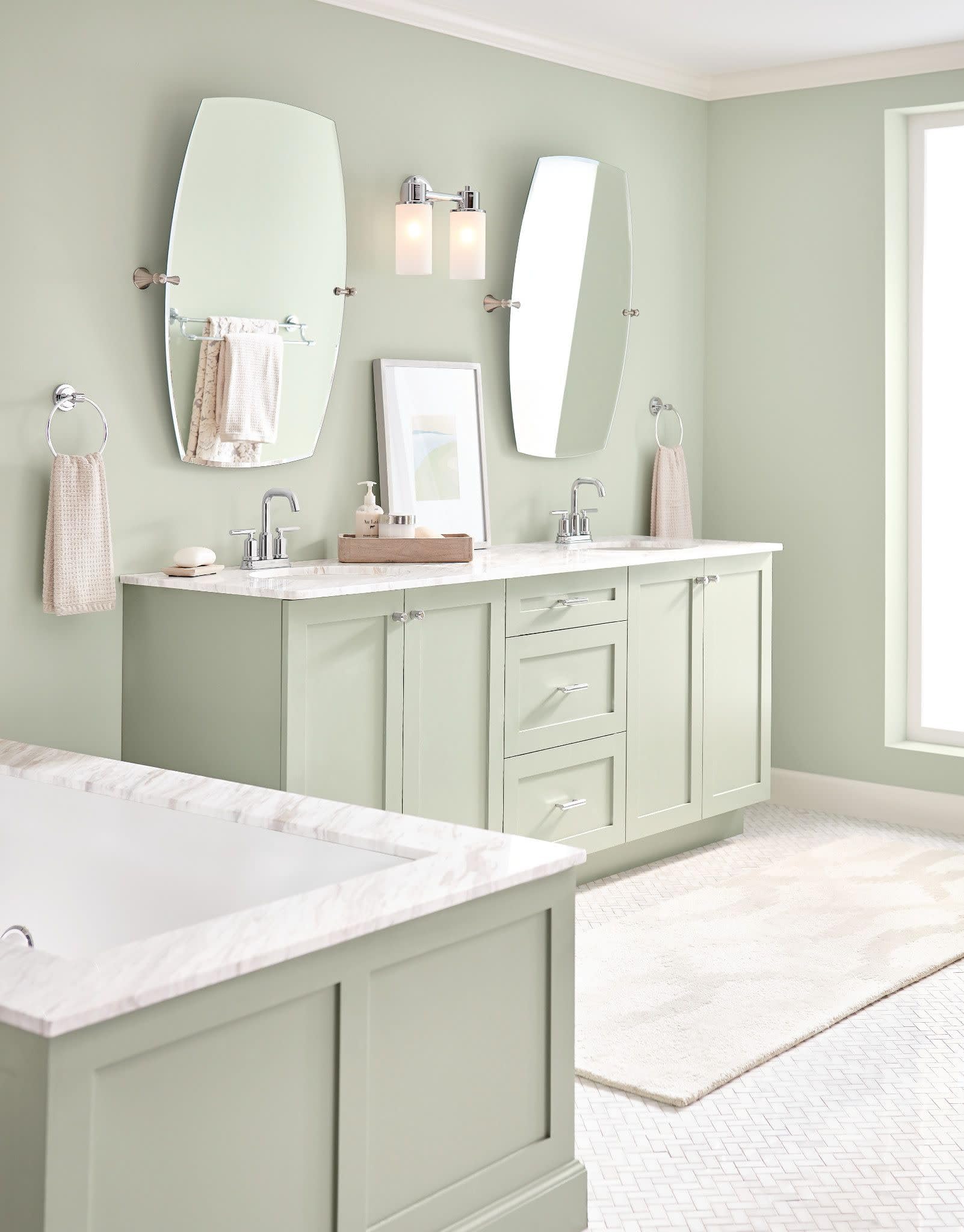 Chrome two-handle centerset bathroom faucet with spout mounted on marble countertop.