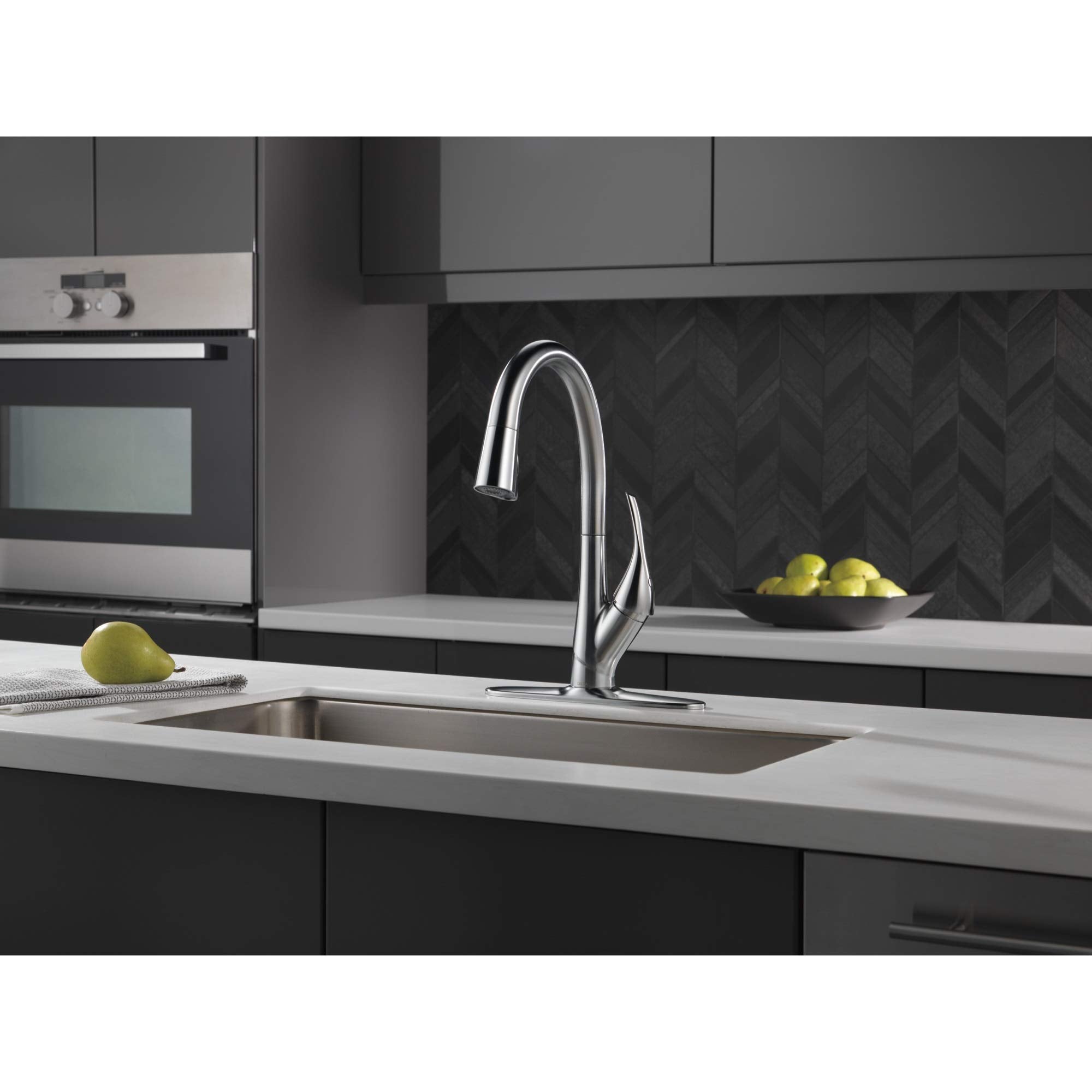 Stainless steel escutcheon with baseplate and mounting nuts for kitchen sink faucet installation.