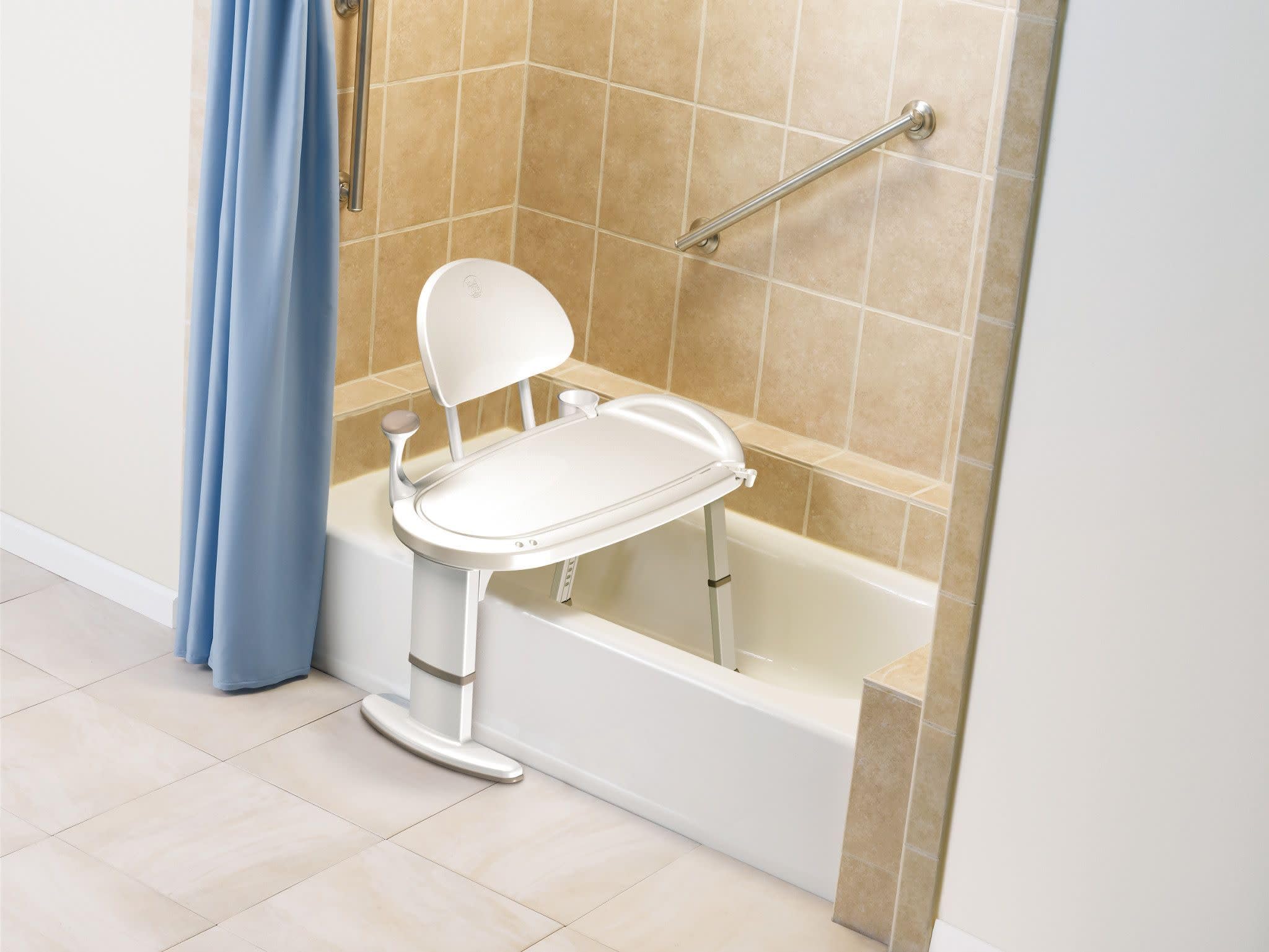 White bath transfer bench with backrest positioned inside a bathtub next to grab bars.