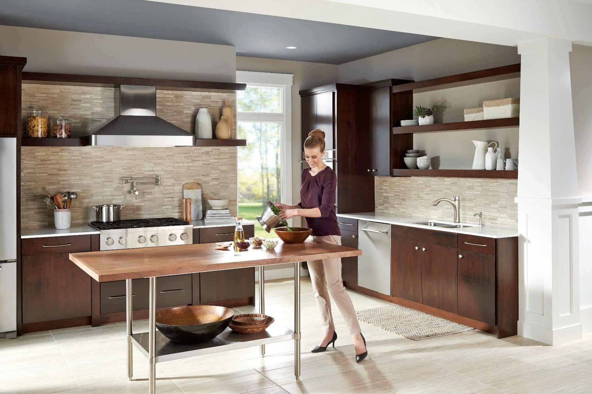 Stainless steel soap dispenser mounted on kitchen sink countertop in transitional kitchen setting.