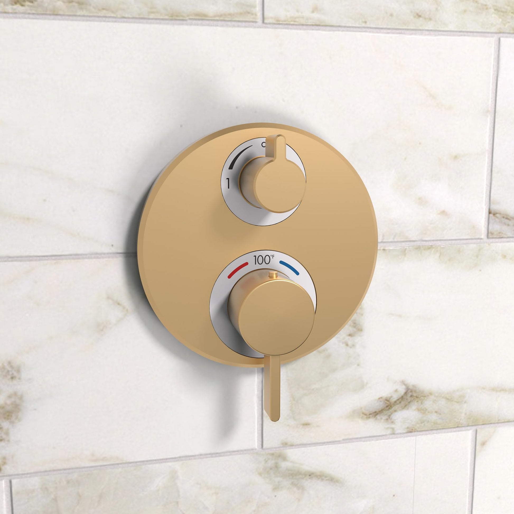 Brushed bronze circular thermostatic trim with dual control handles mounted on marble tile wall.