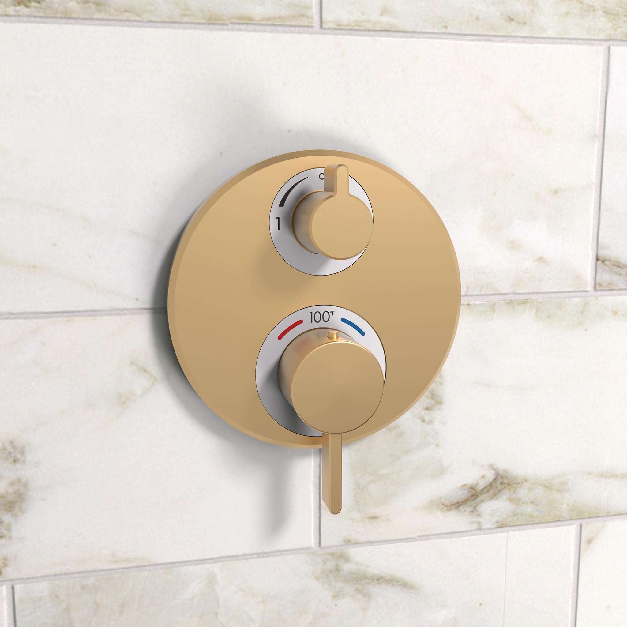 Brushed bronze circular thermostatic trim with dual control handles mounted on marble tile wall.