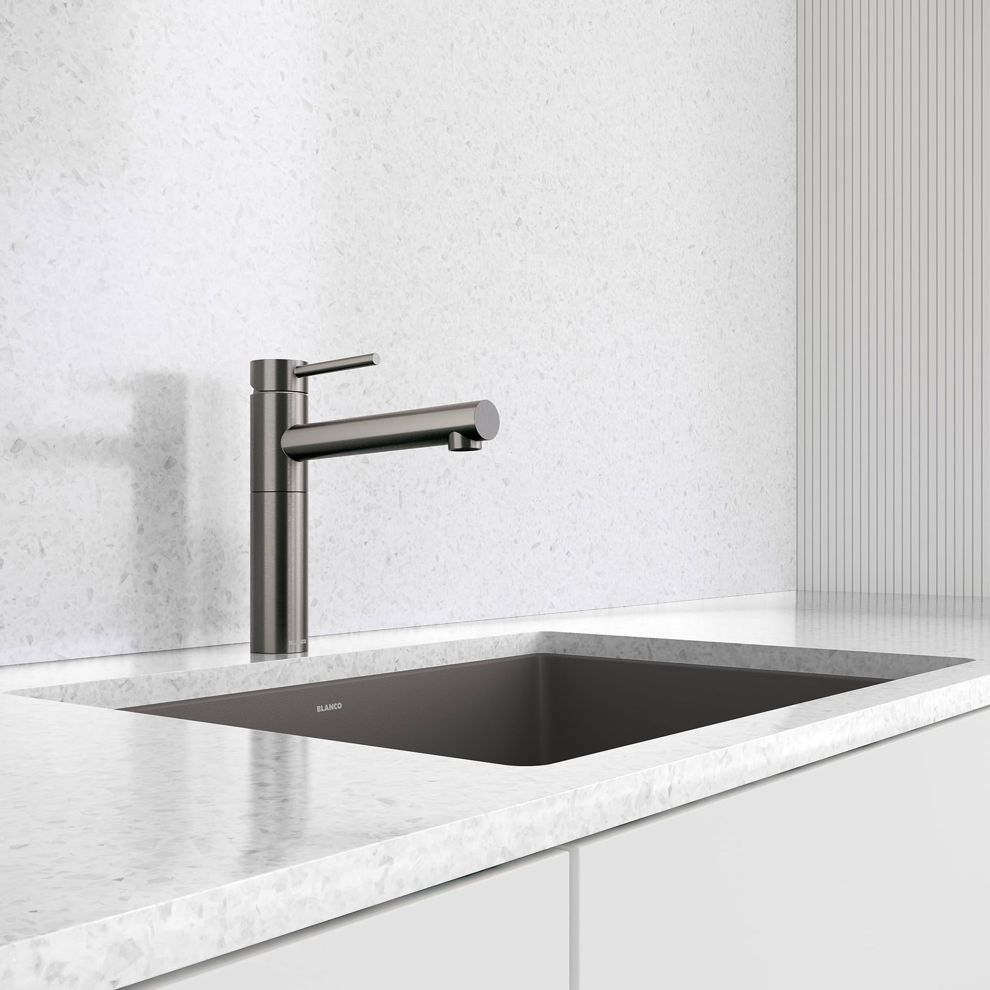 Satin dark steel bar-style faucet with single lever handle installed above rectangular black sink on marble countertop.