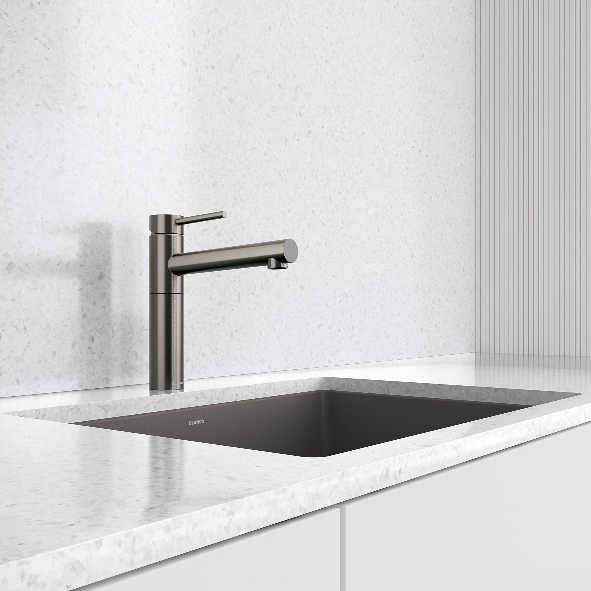 Satin dark steel bar-style faucet with single lever handle installed above rectangular black sink on marble countertop.