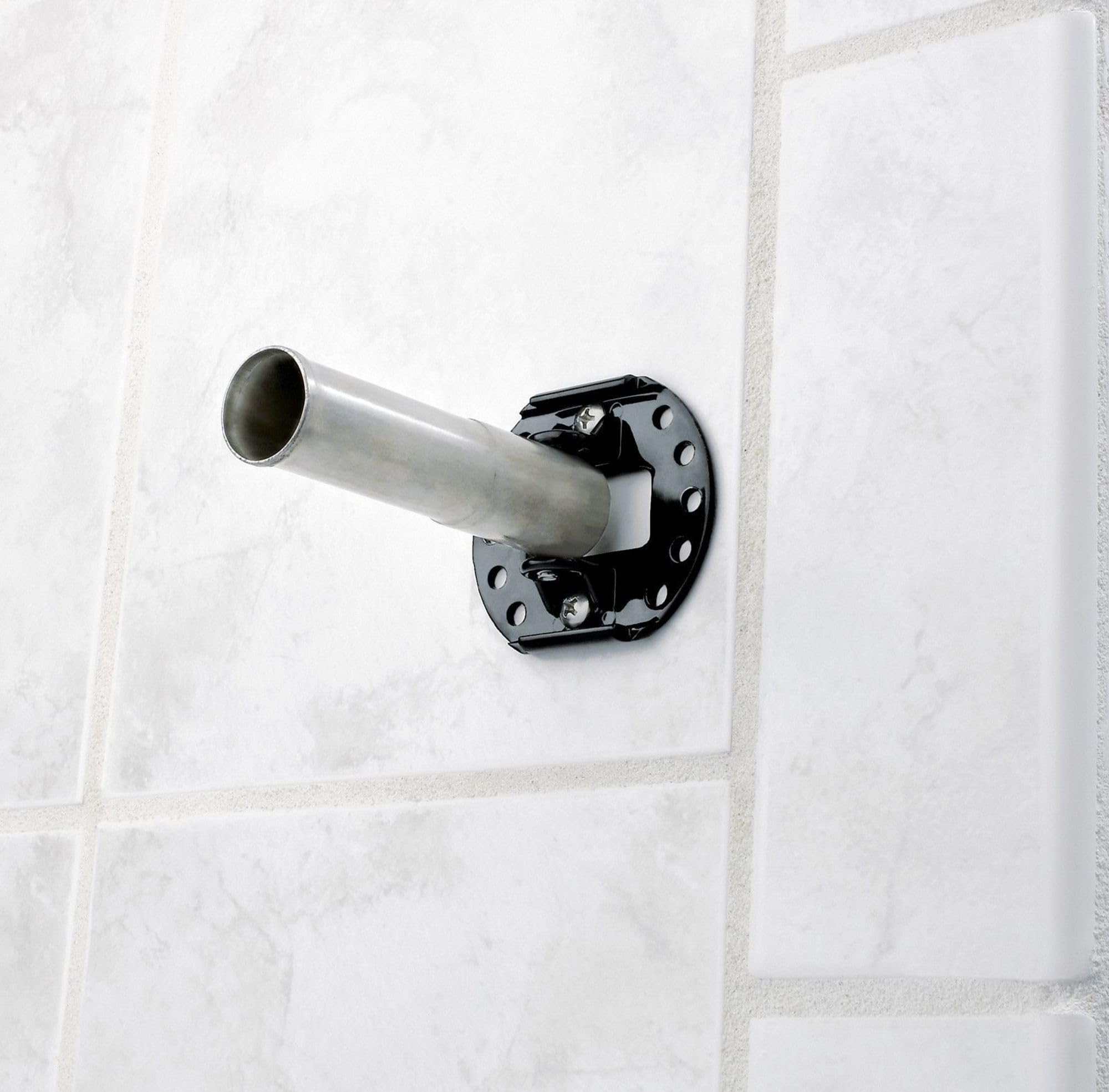 Curved chrome shower rod with black mounting bracket installed on white tile wall.