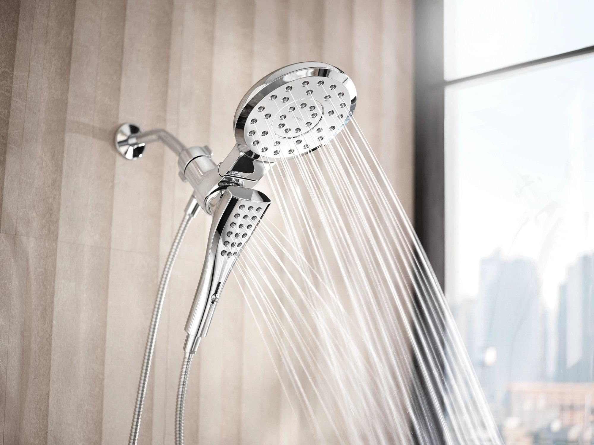 Chrome dual shower head system with upper fixed head and lower handheld head with hose attachment.