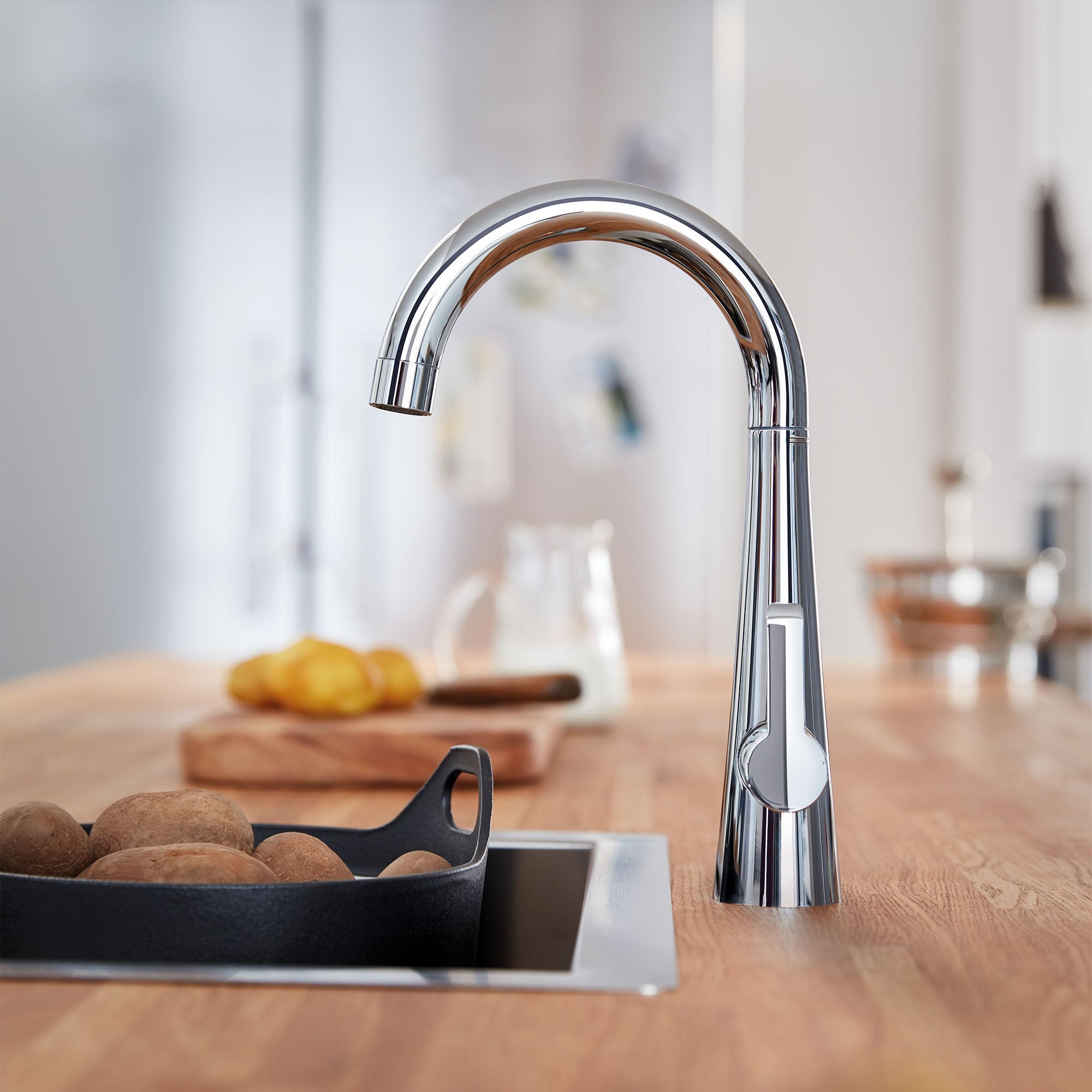 Grohe Zedra chrome single-handle beverage faucet with curved spout on kitchen counter.