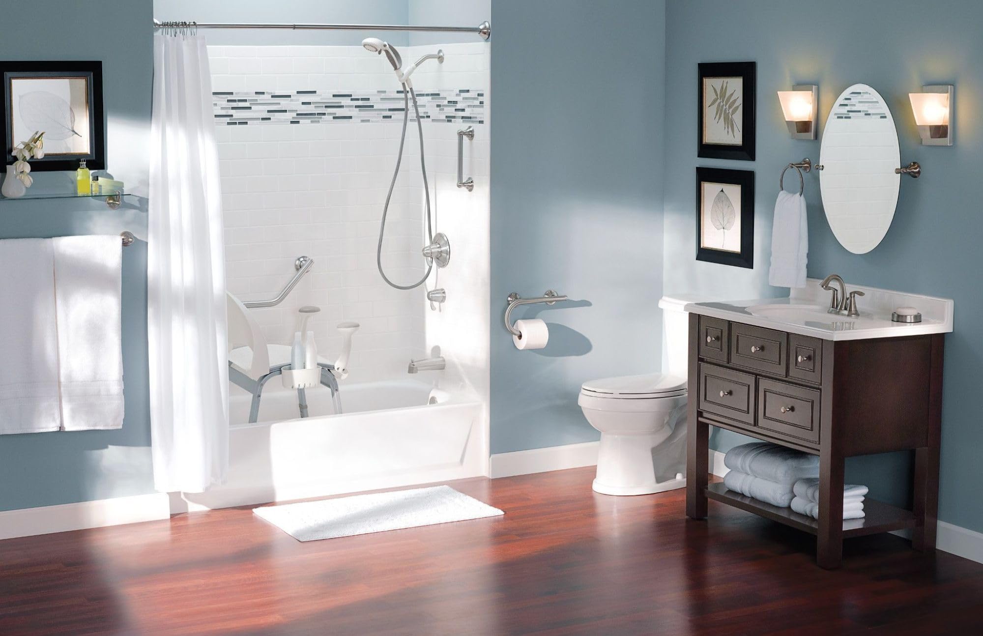 Chrome grab bar with integrated towel bar mounted on blue bathroom wall above toilet.
