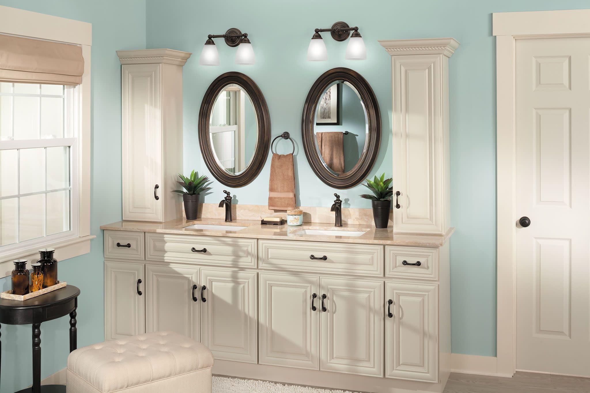 Oil-rubbed bronze single-handle bathroom faucet with low arc spout displayed on a dual-sink vanity.