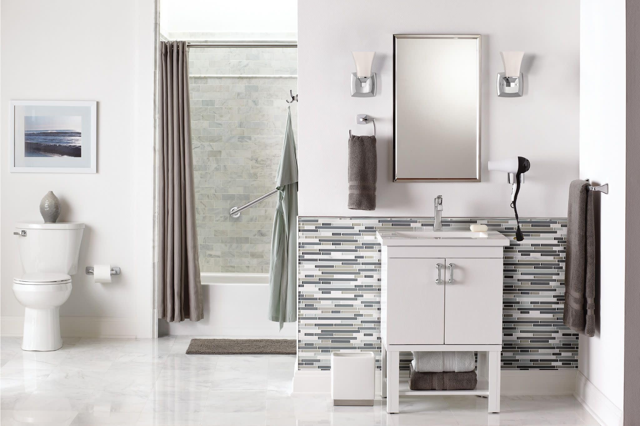 Chrome single-handle bathroom sink faucet with tall spout installed on white vanity in modern bathroom setting.