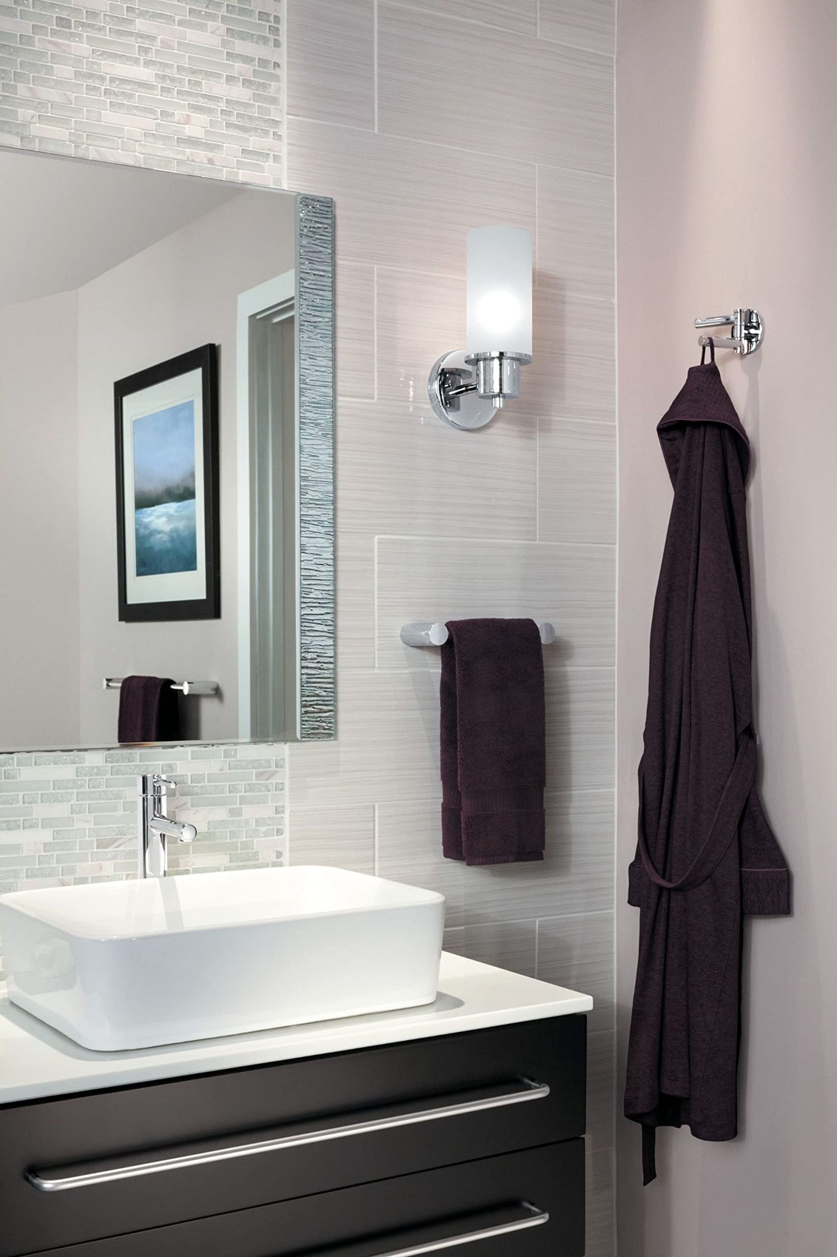 Chrome double swivel robe hook mounted on bathroom tile wall with dark robe hanging from it.