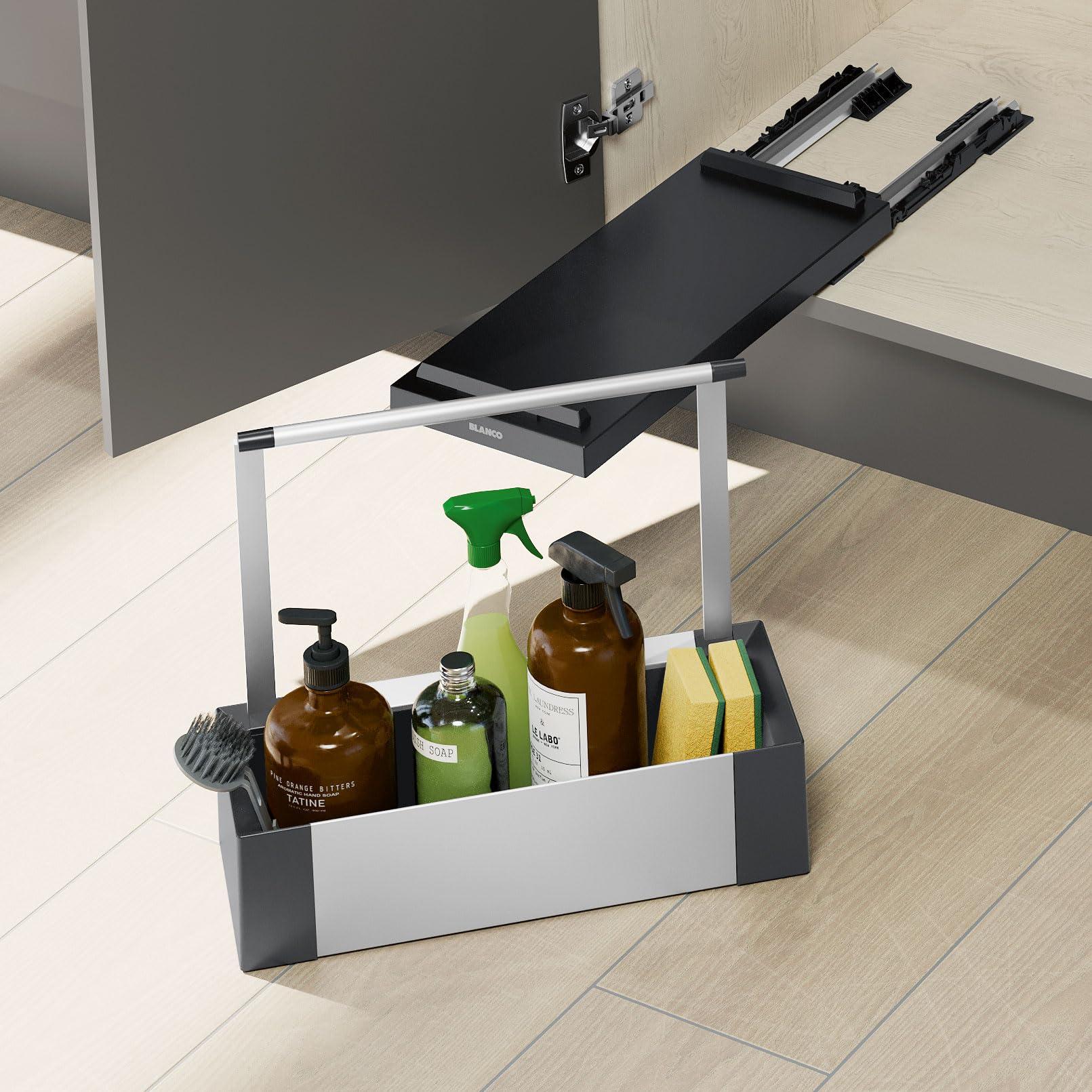 Black and white pull-out storage caddy with compartments holding bottles, spray bottles, and cleaning supplies under a kitche
