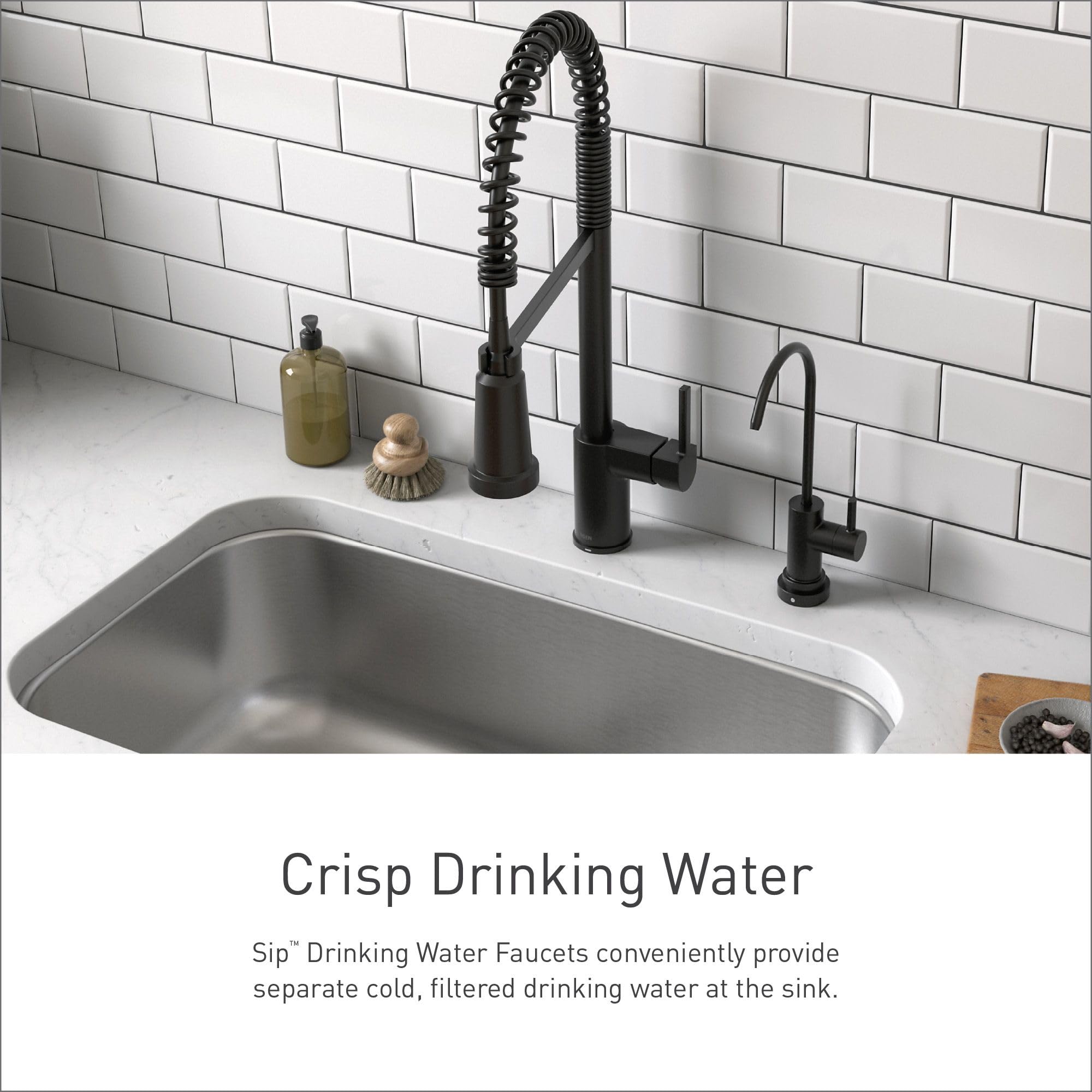 Black stainless steel drinking water faucet with coiled sprayer installed at kitchen sink next to main faucet.
